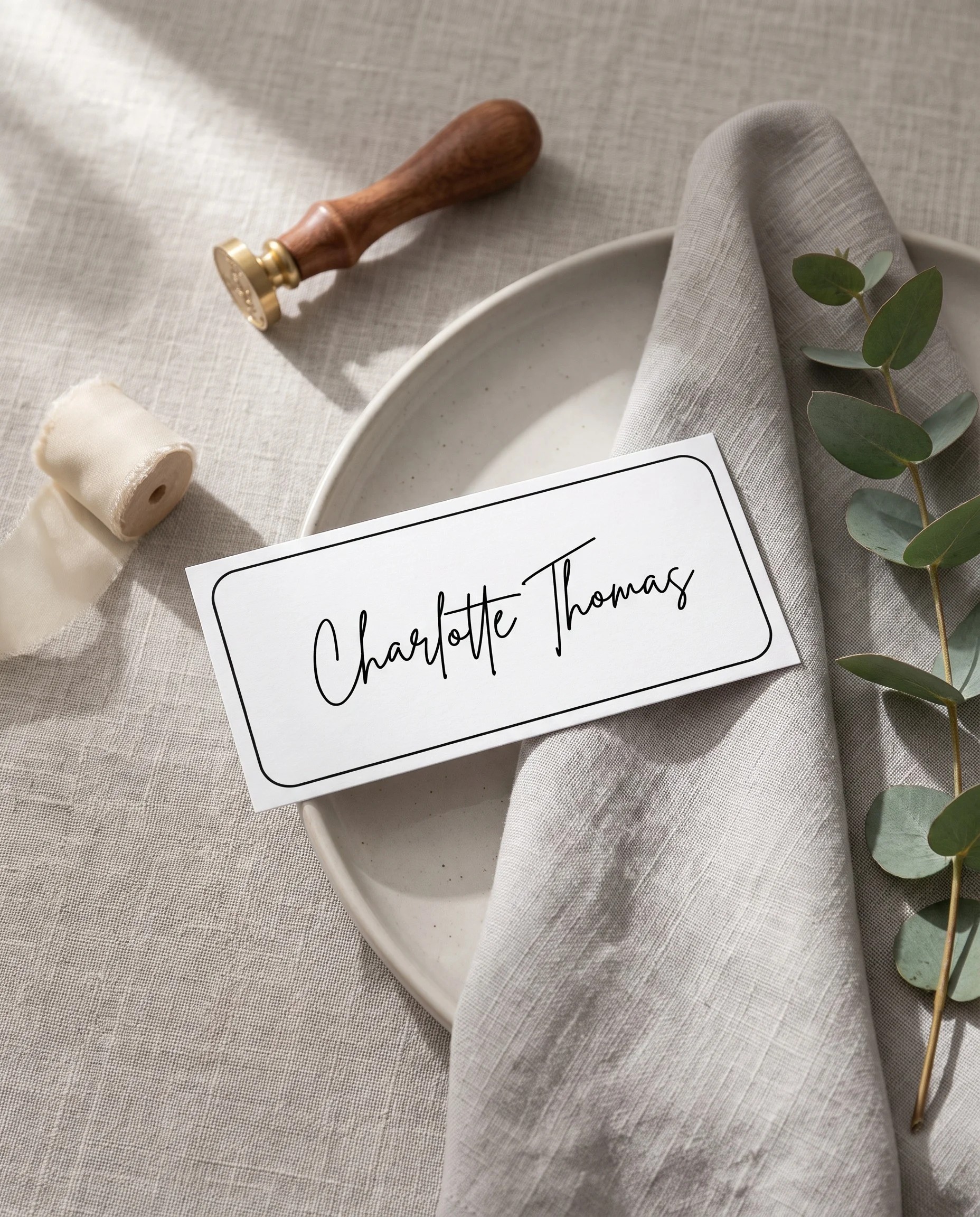 Contour wedding place cards — a single place card displayed at a set place setting under soft overhead natural light, wedding name cards.