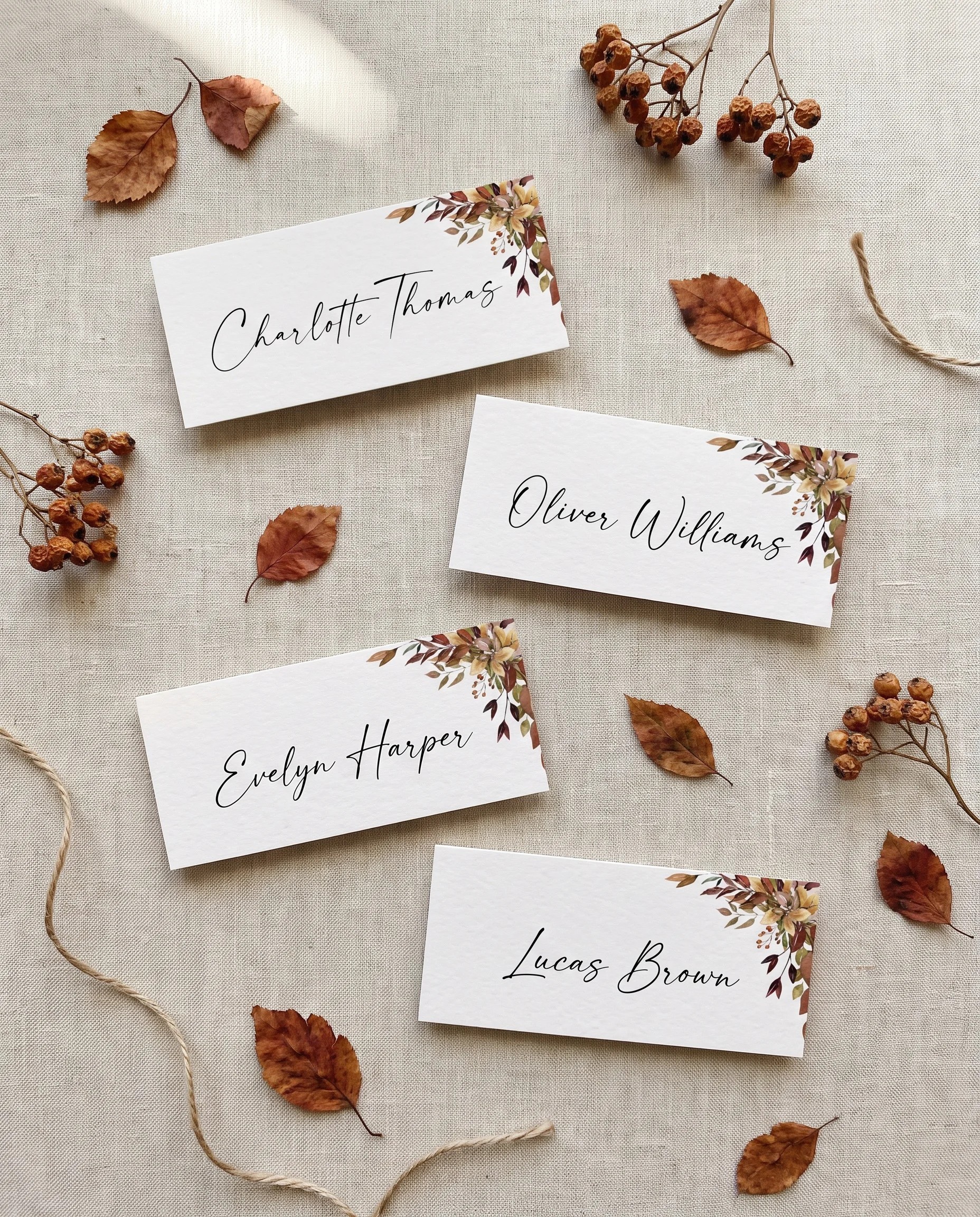 Autumn Bough wedding place cards — several place cards shown flat under soft natural light at a slight overhead angle, wedding place cards.
