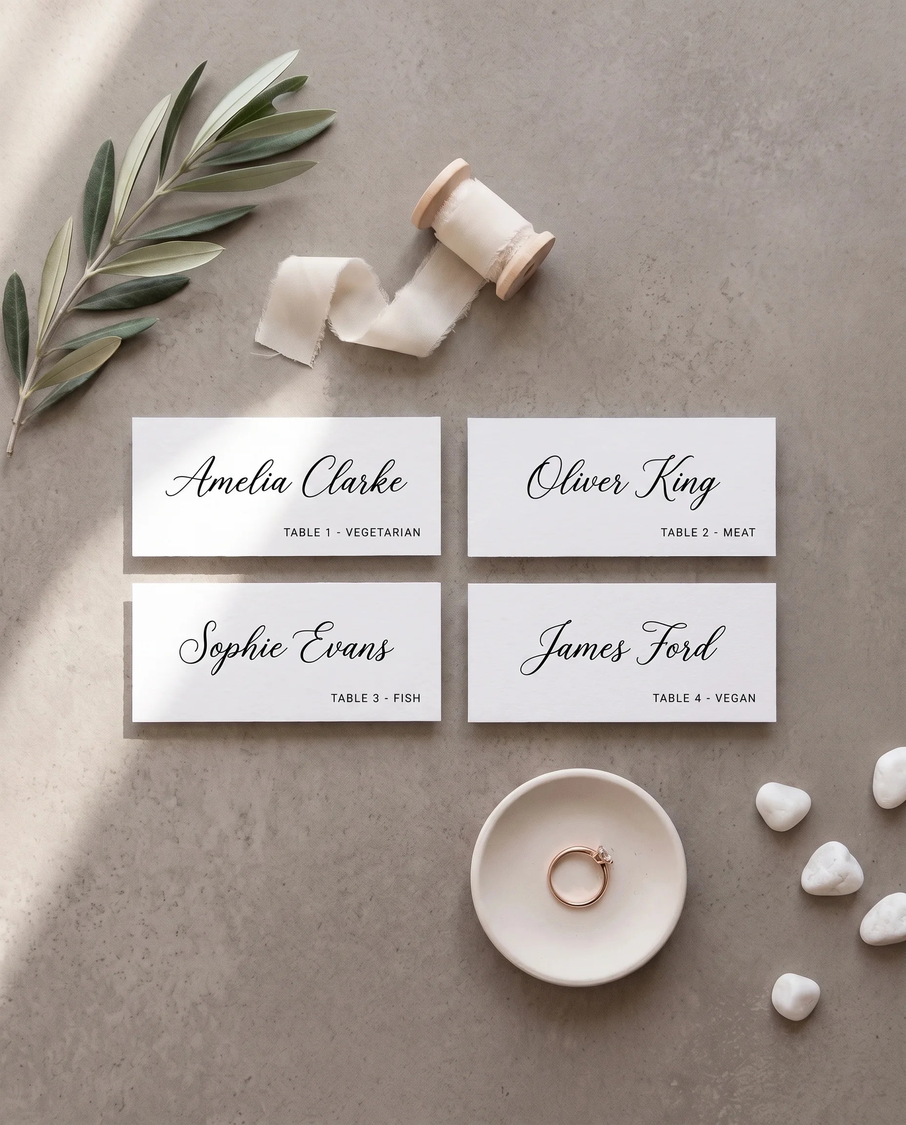Lyris wedding place cards — flat lay of several place cards viewed from a slight overhead angle in soft natural light, wedding place cards.