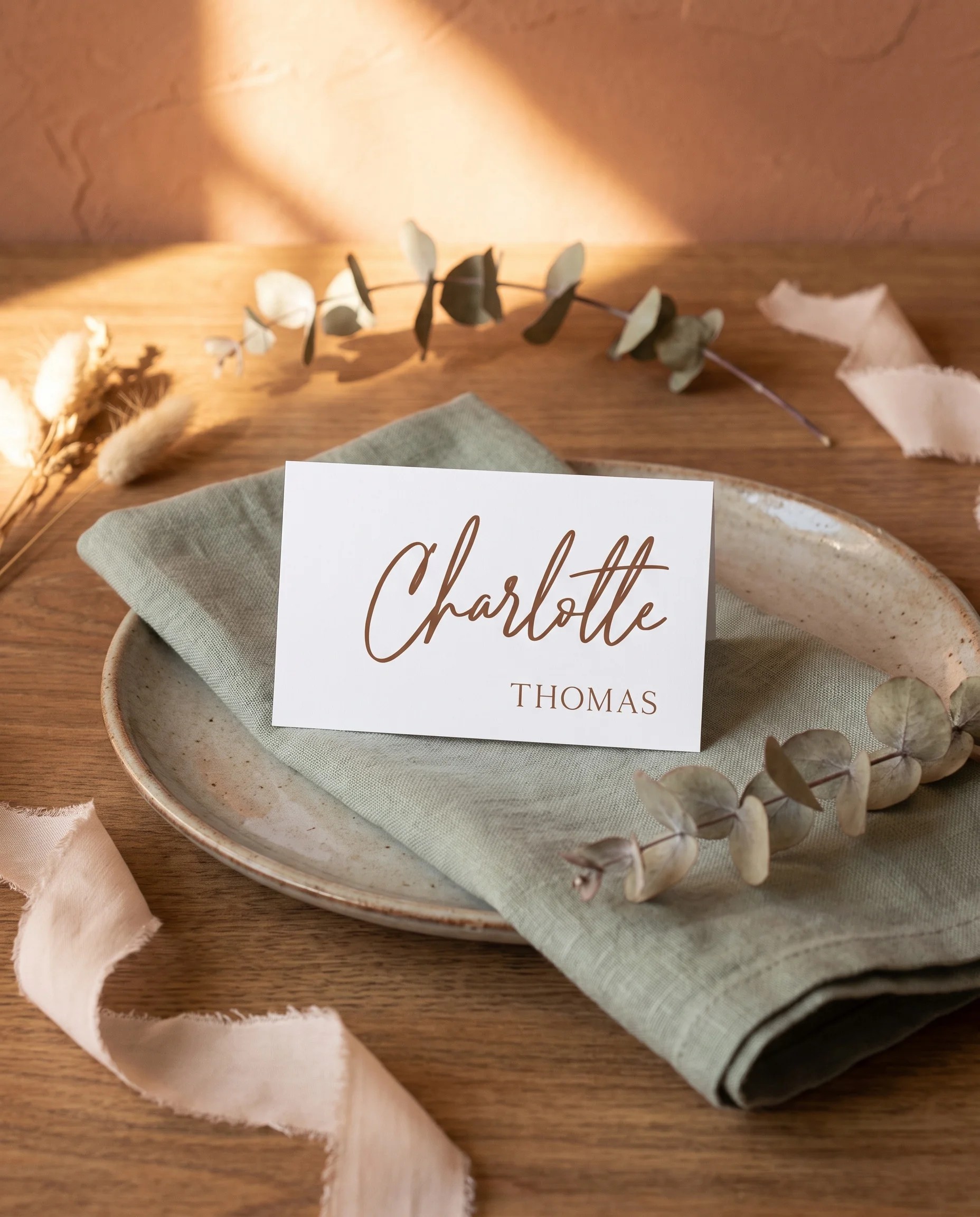 Briar Script wedding place cards — a place card displayed at a set table setting under soft natural light, wedding name cards.