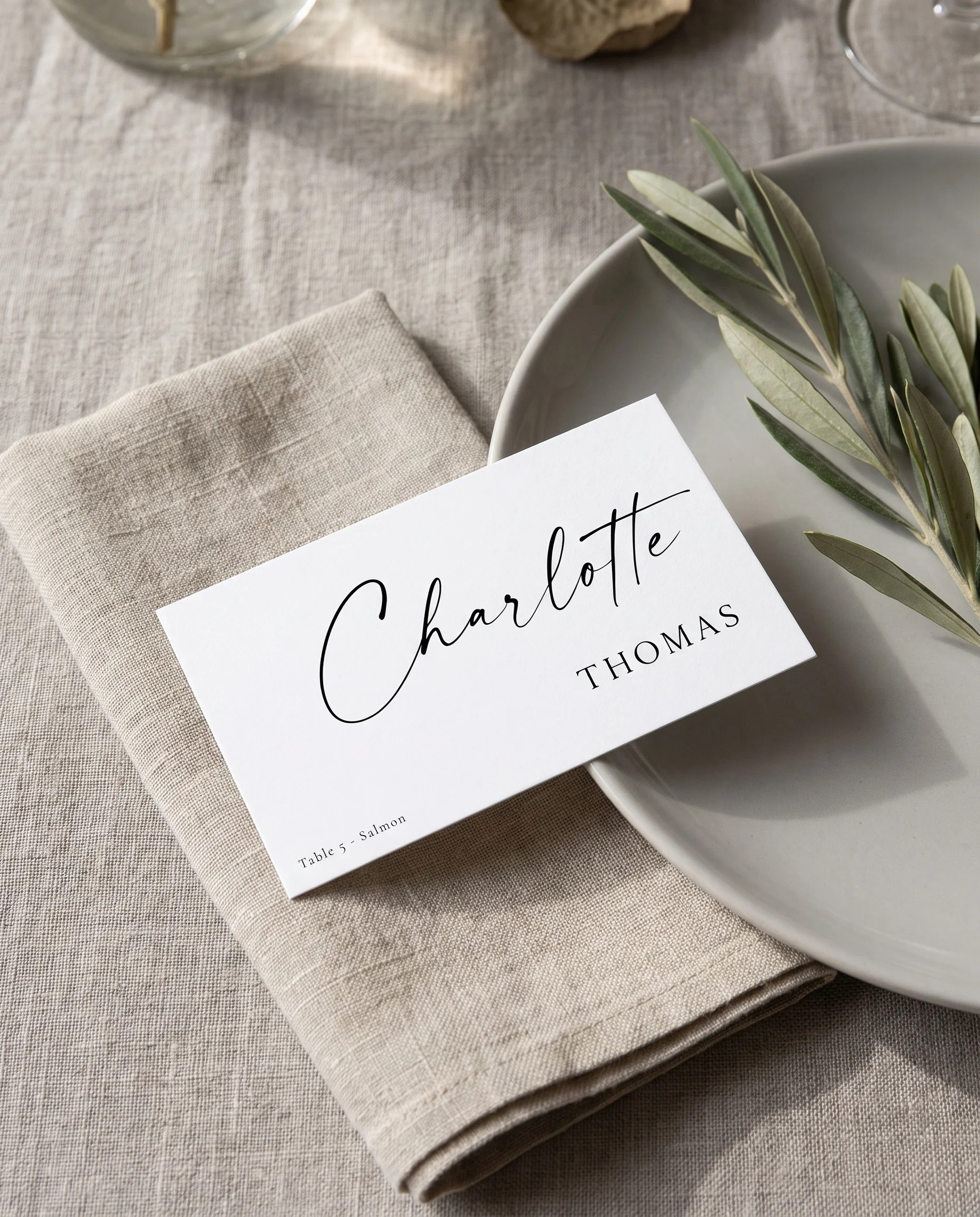 Liminal wedding place cards — a single place card shown at a set place setting under soft natural light, wedding name cards.