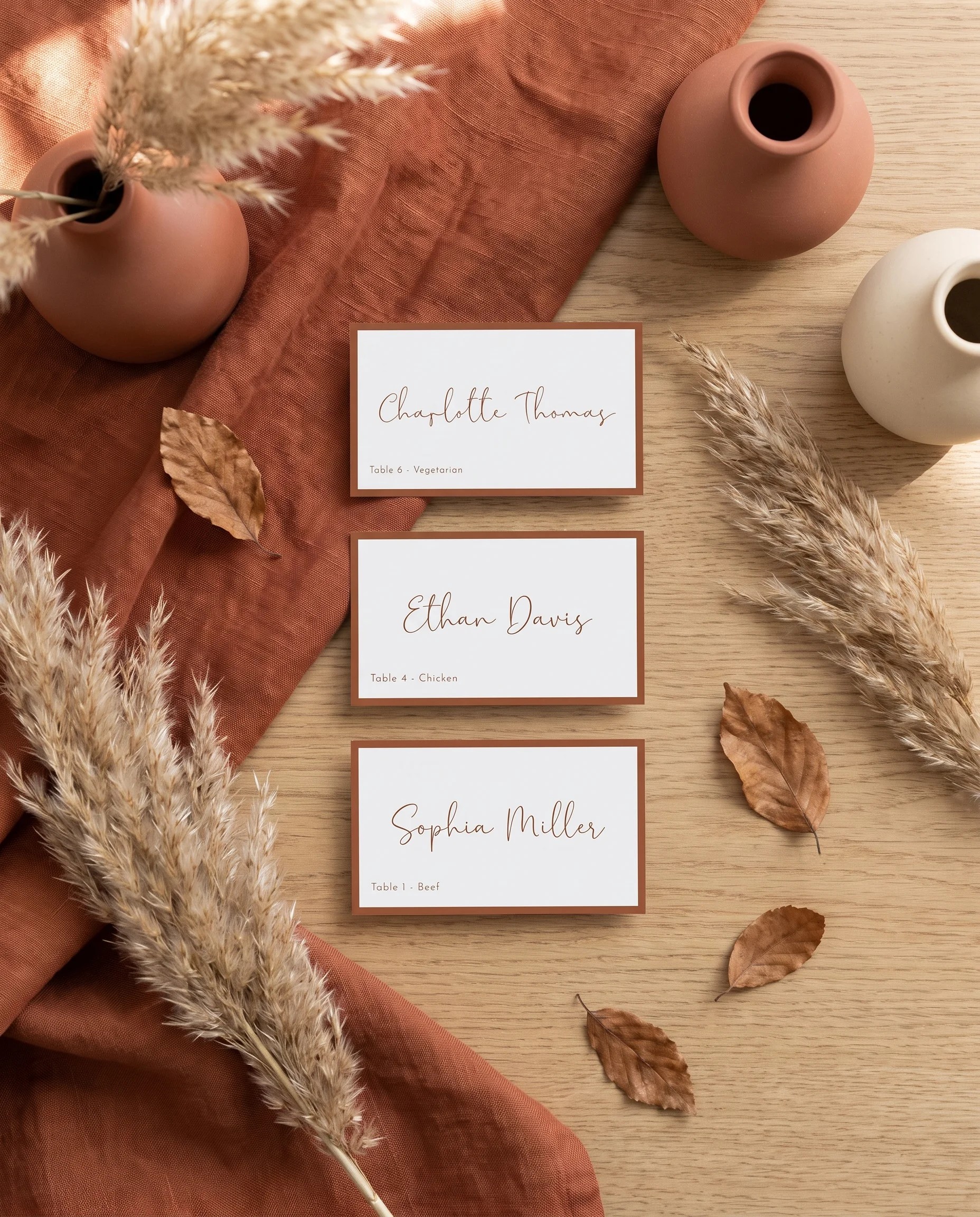 Stevens wedding place cards — several cards shown flat in an overhead view under soft natural light, wedding place cards