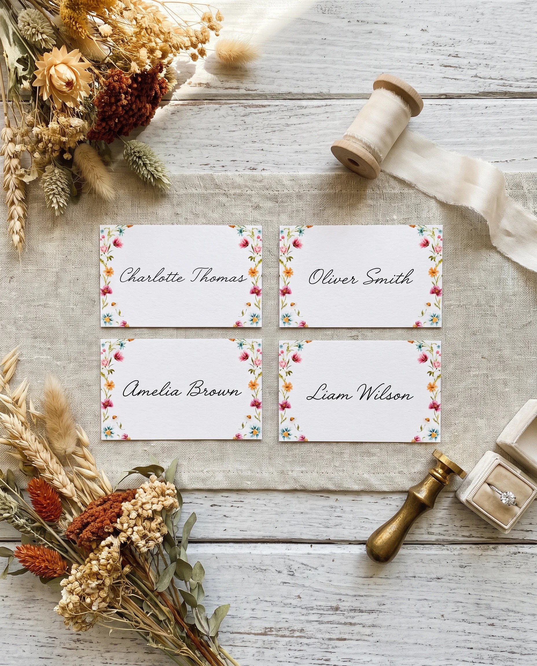 Meadow Ring wedding place cards — several place cards shown flat under soft natural light on premium editorial paper, wedding place cards.