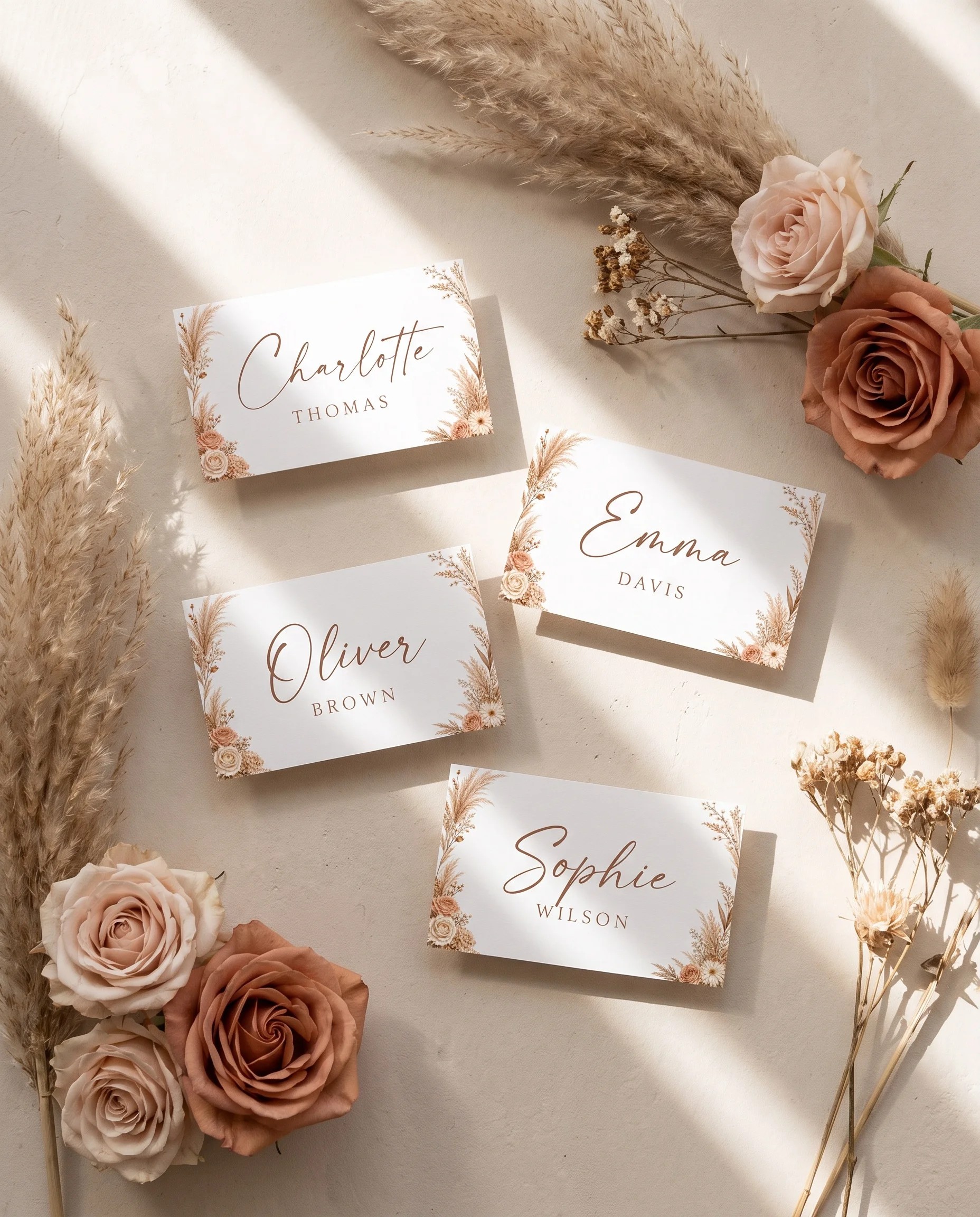 Pampas Hush wedding place cards — flat lay view of several place cards on premium editorial paper under soft natural light, wedding place cards.