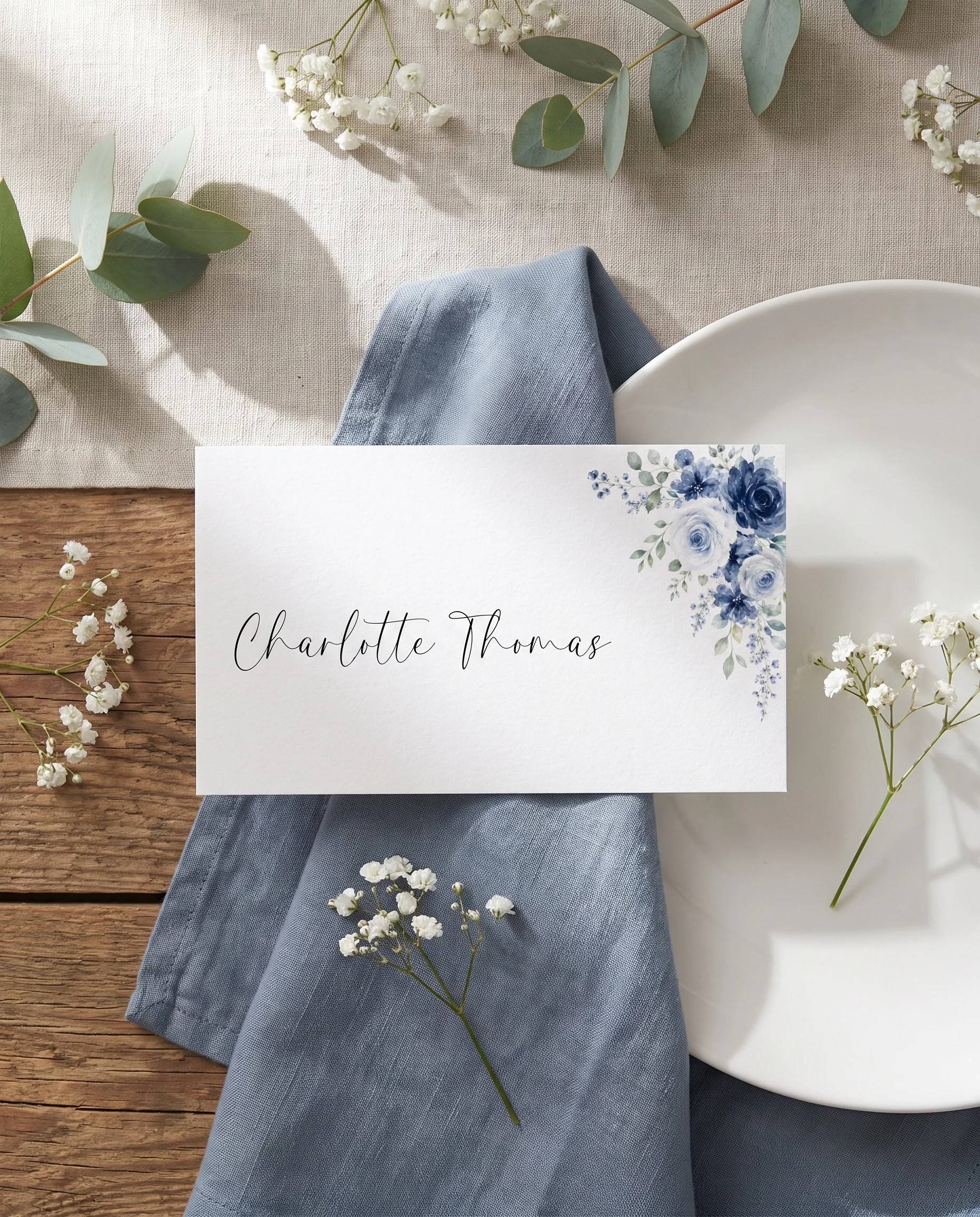 Bluebloom wedding place cards — a single card displayed at a set place setting under soft natural light, wedding name cards