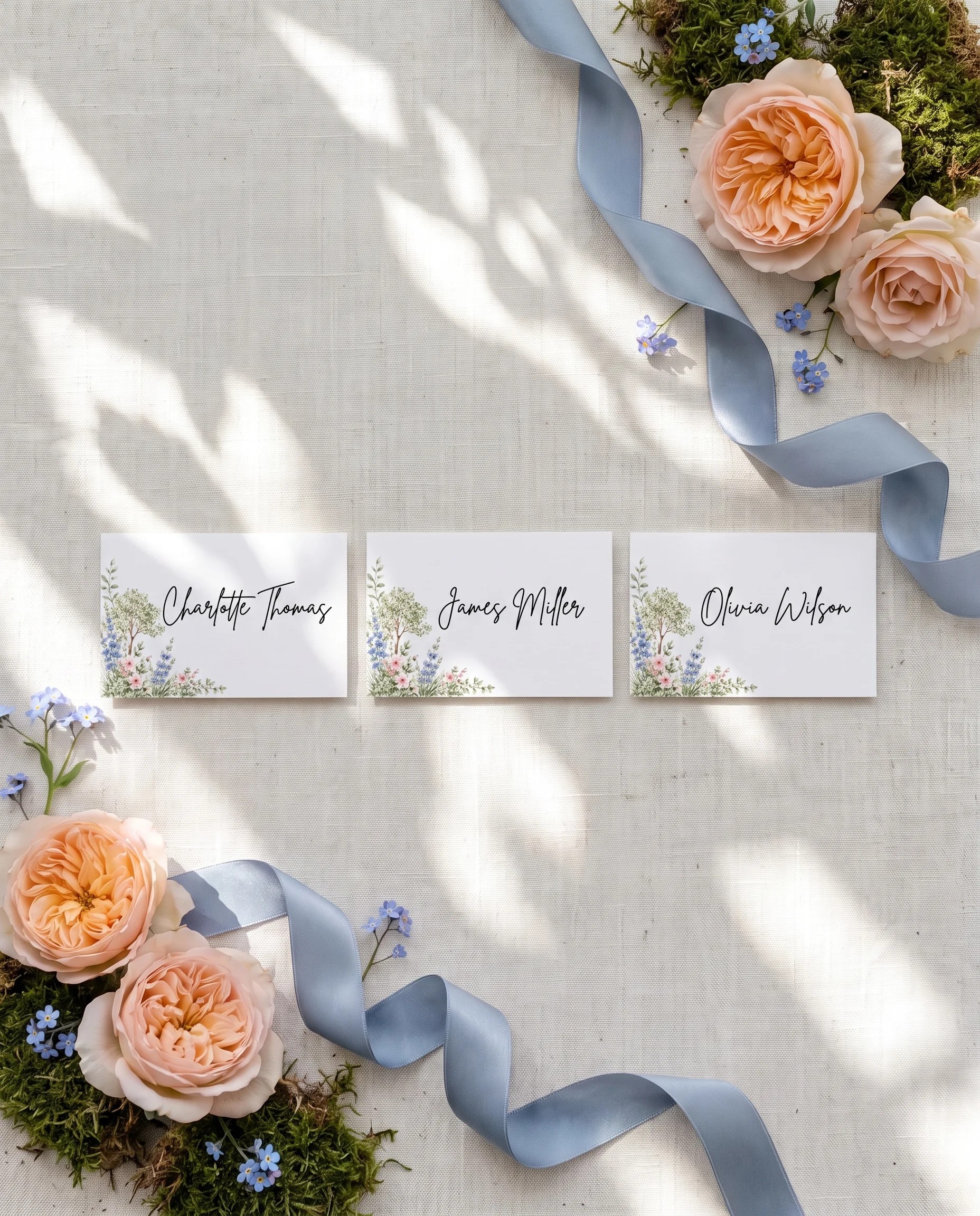 Meadow Spire wedding place cards — several place cards shown flat under soft natural light on premium editorial paper, wedding place cards.
