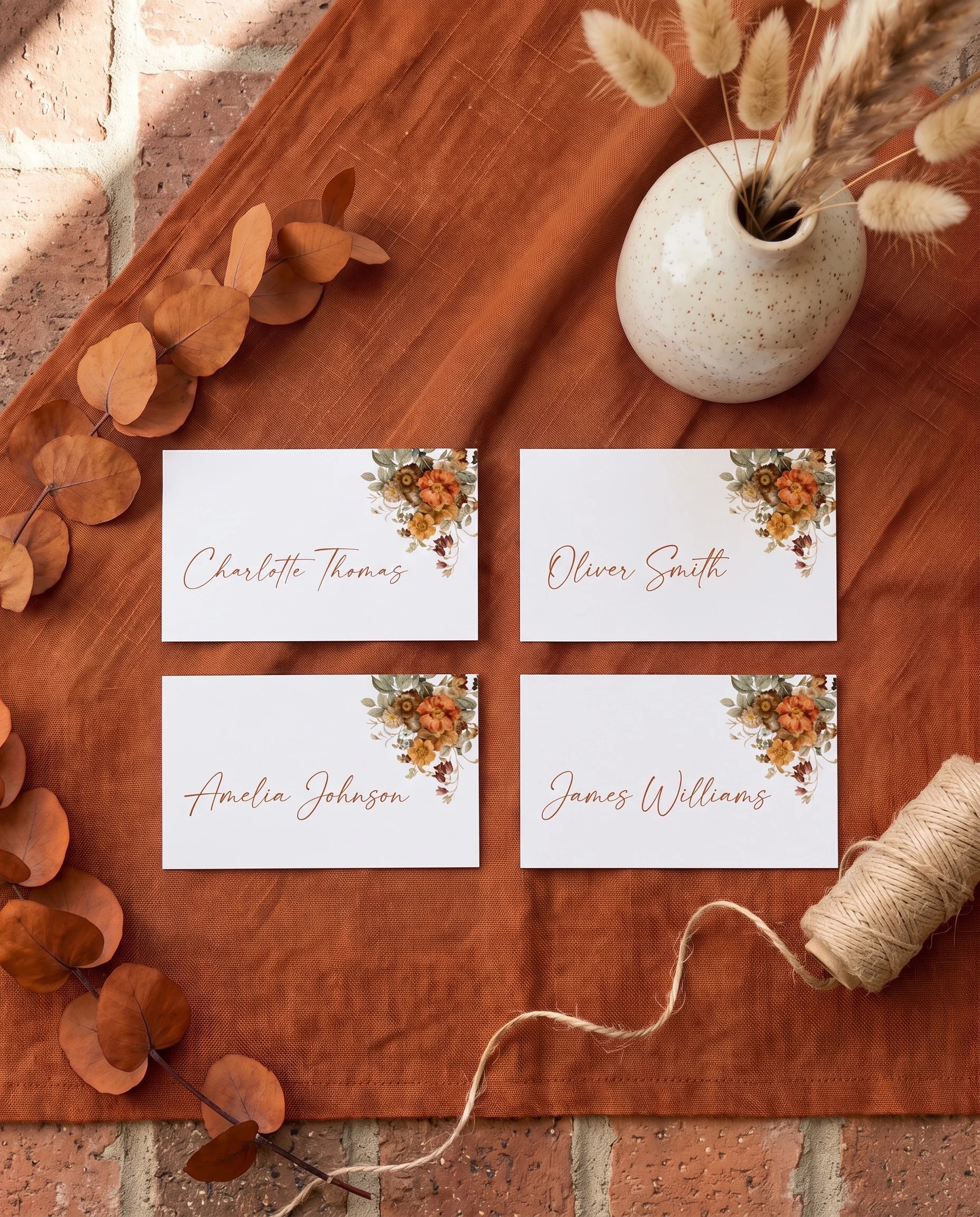 Terracotta Crown wedding place cards — several cards shown flat in an overhead editorial layout on soft natural paper, wedding place cards.