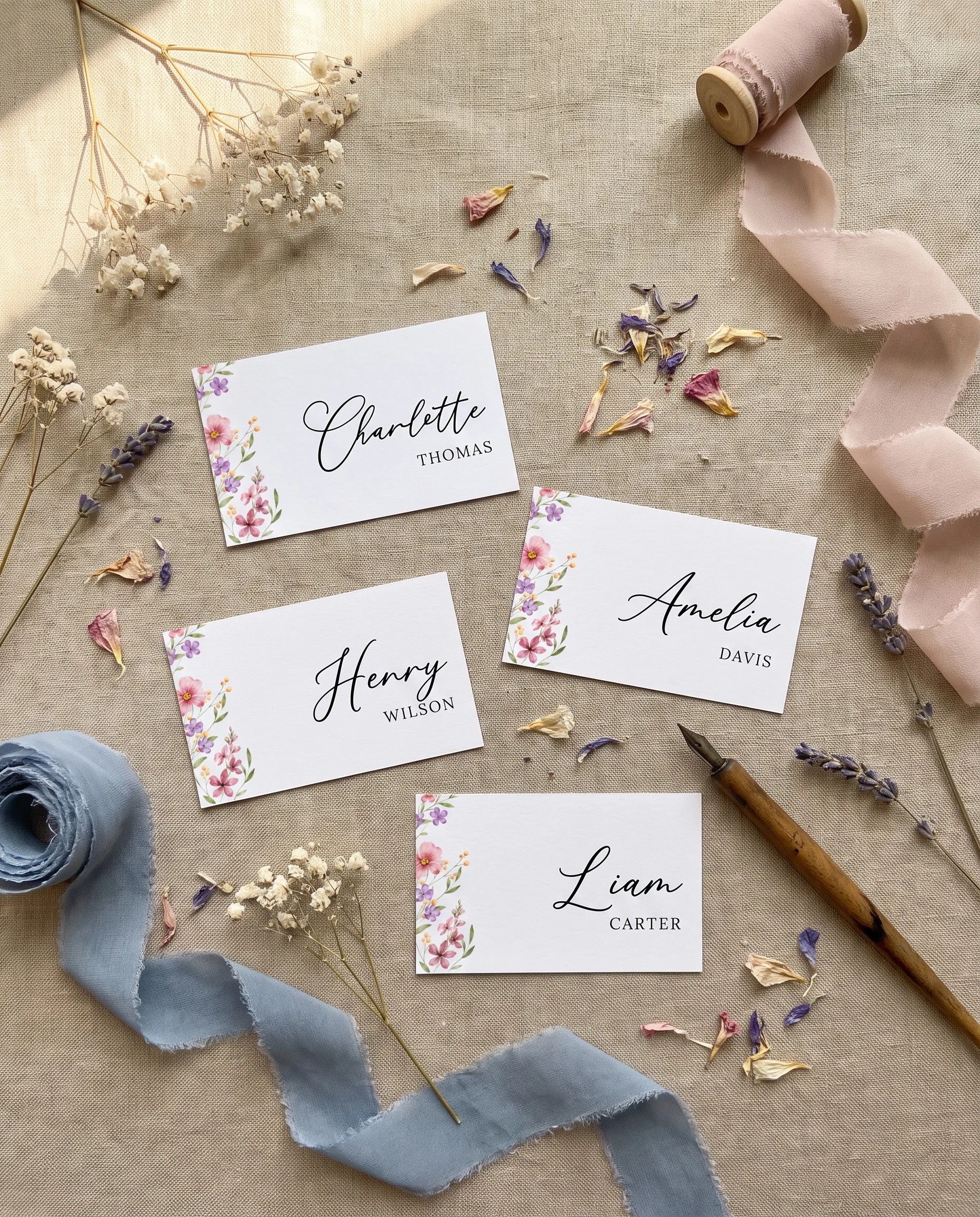 Meadowlark wedding place cards — flat lay of several cards under soft natural light, wedding place cards.