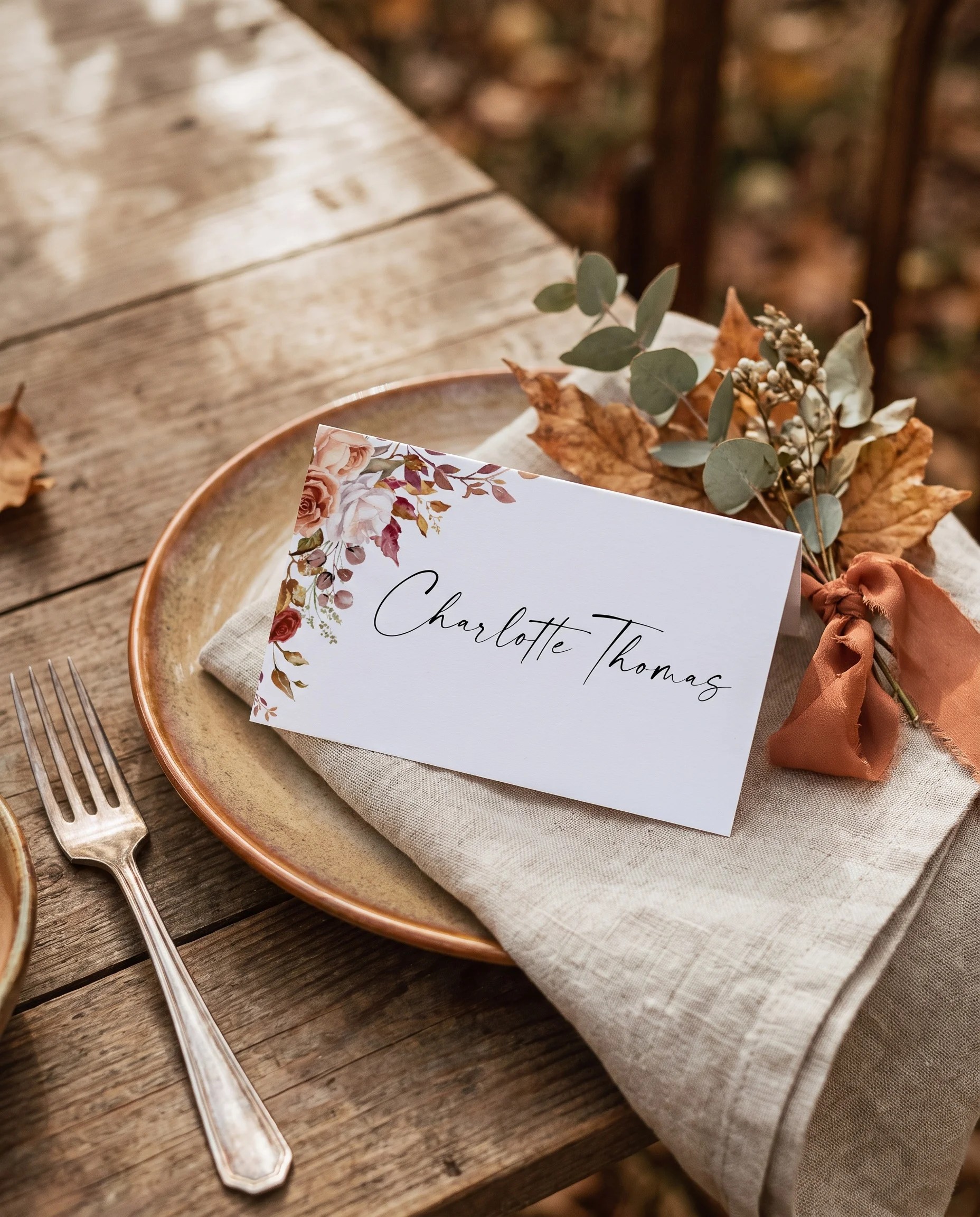 Autumn Bloom wedding place cards — single card displayed at a set place setting under soft natural light, wedding name cards.