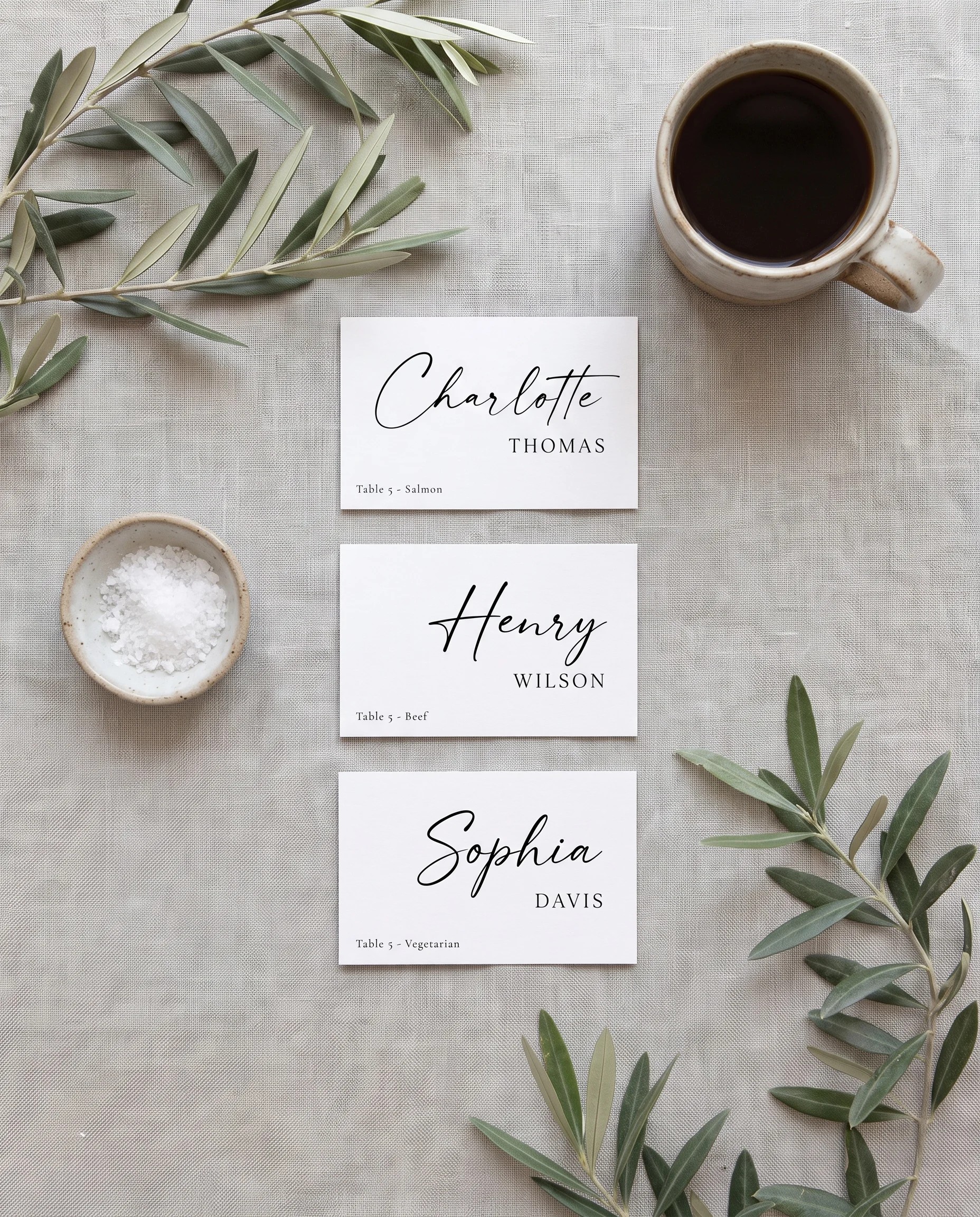 Liminal wedding place cards — several place cards shown flat under soft natural light with a slight overhead angle, wedding place cards.