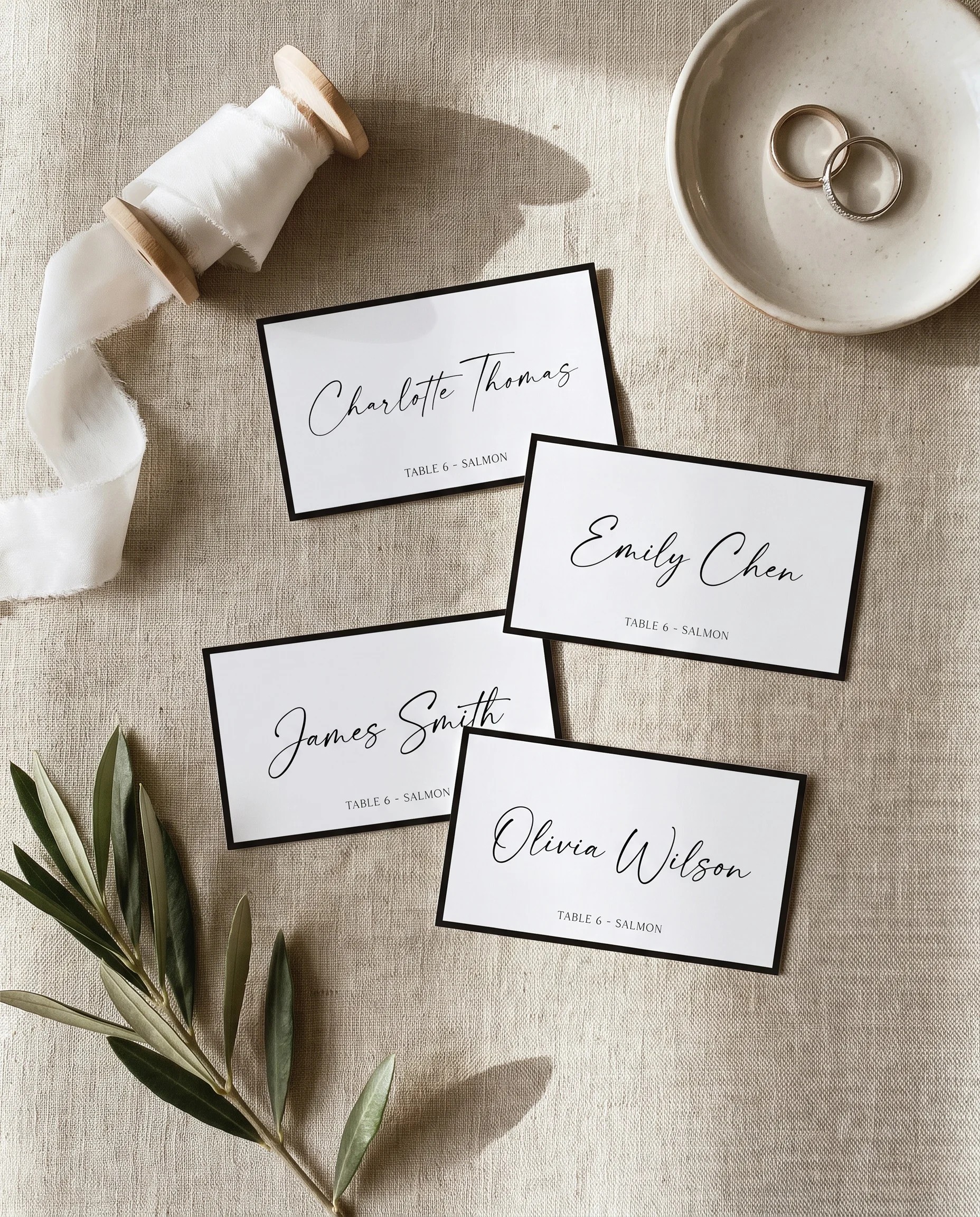 Lumen Frame wedding place cards — several cards shown flat under soft natural light at a slight overhead angle, wedding place cards.