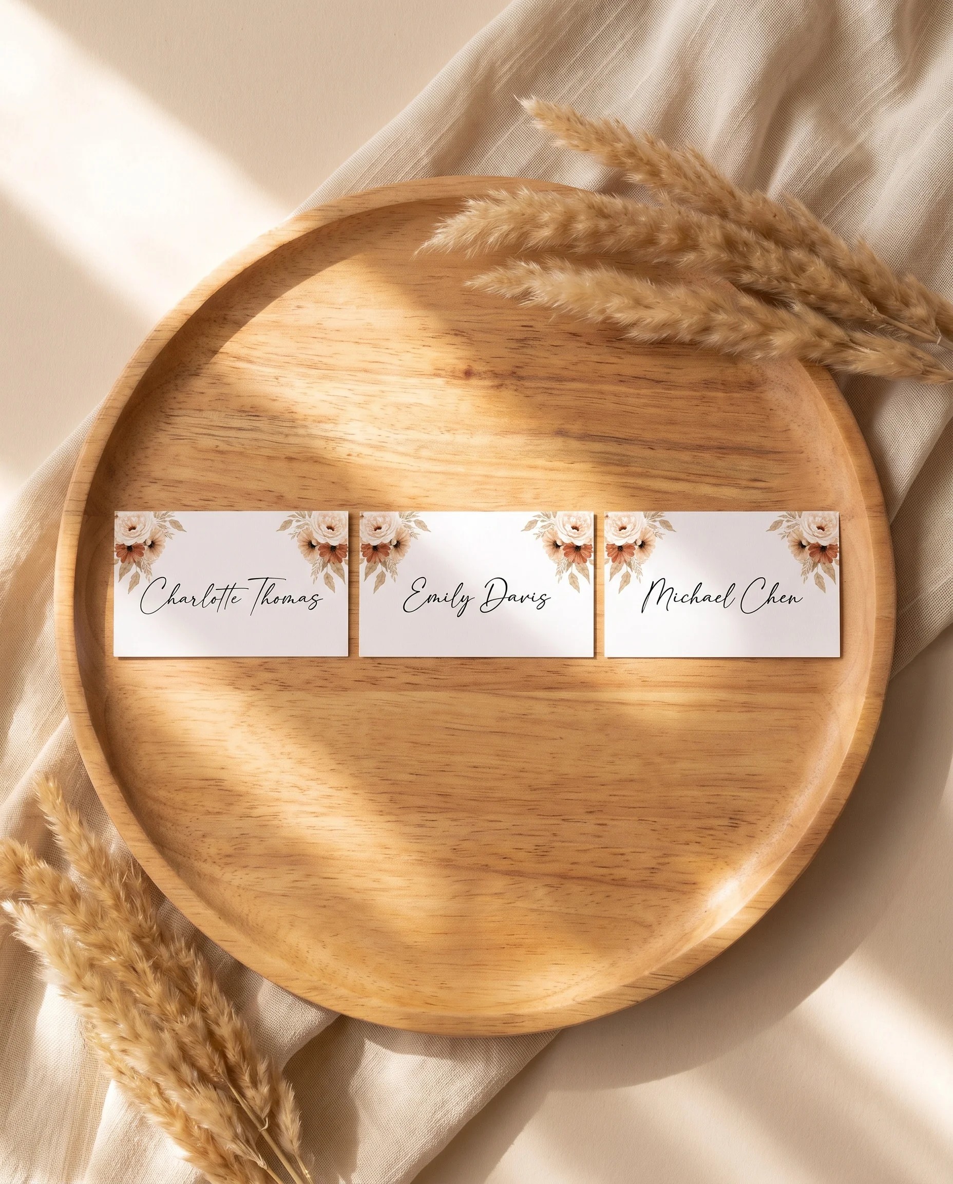Pampas Bloom wedding place cards — several cards shown flat in an overhead view under soft natural light, wedding place cards.