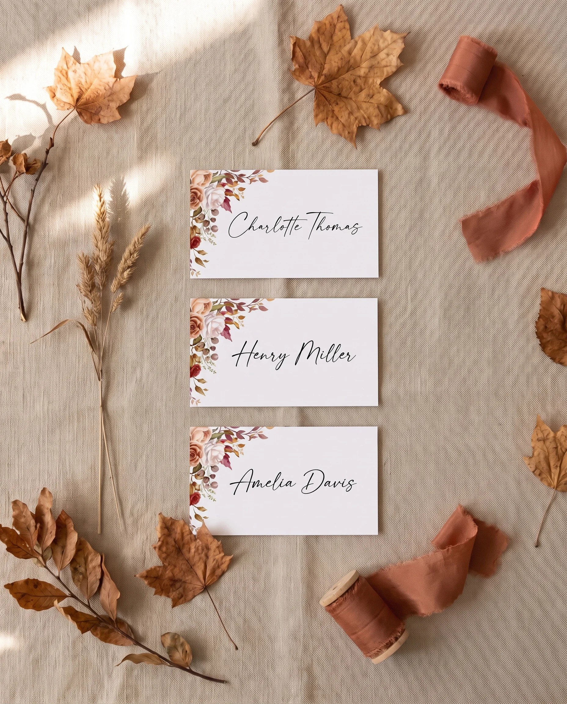 Autumn Bloom wedding place cards — several place cards shown flat in an overhead editorial flat lay, wedding place cards