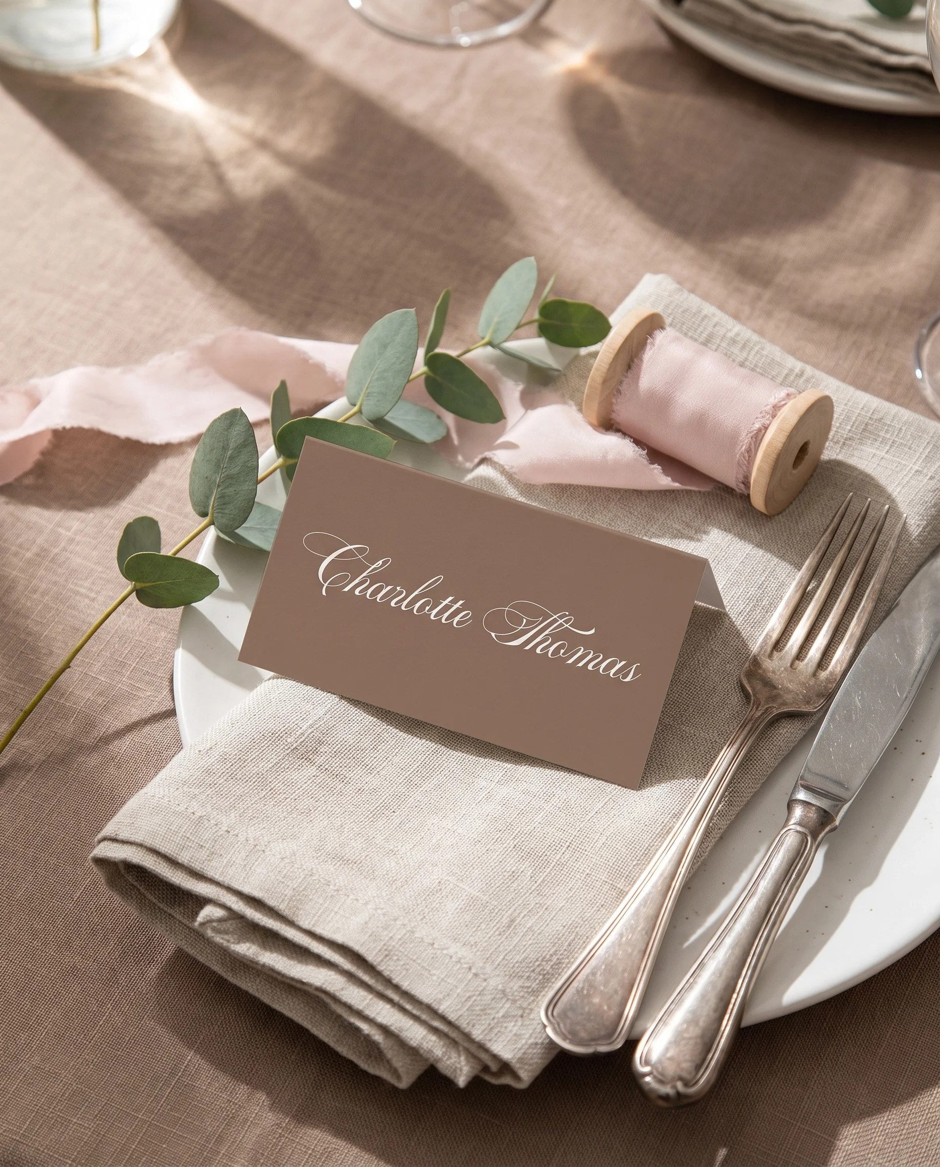 Hinge Script wedding place cards — a place card at a set place setting under soft natural light, wedding name cards.