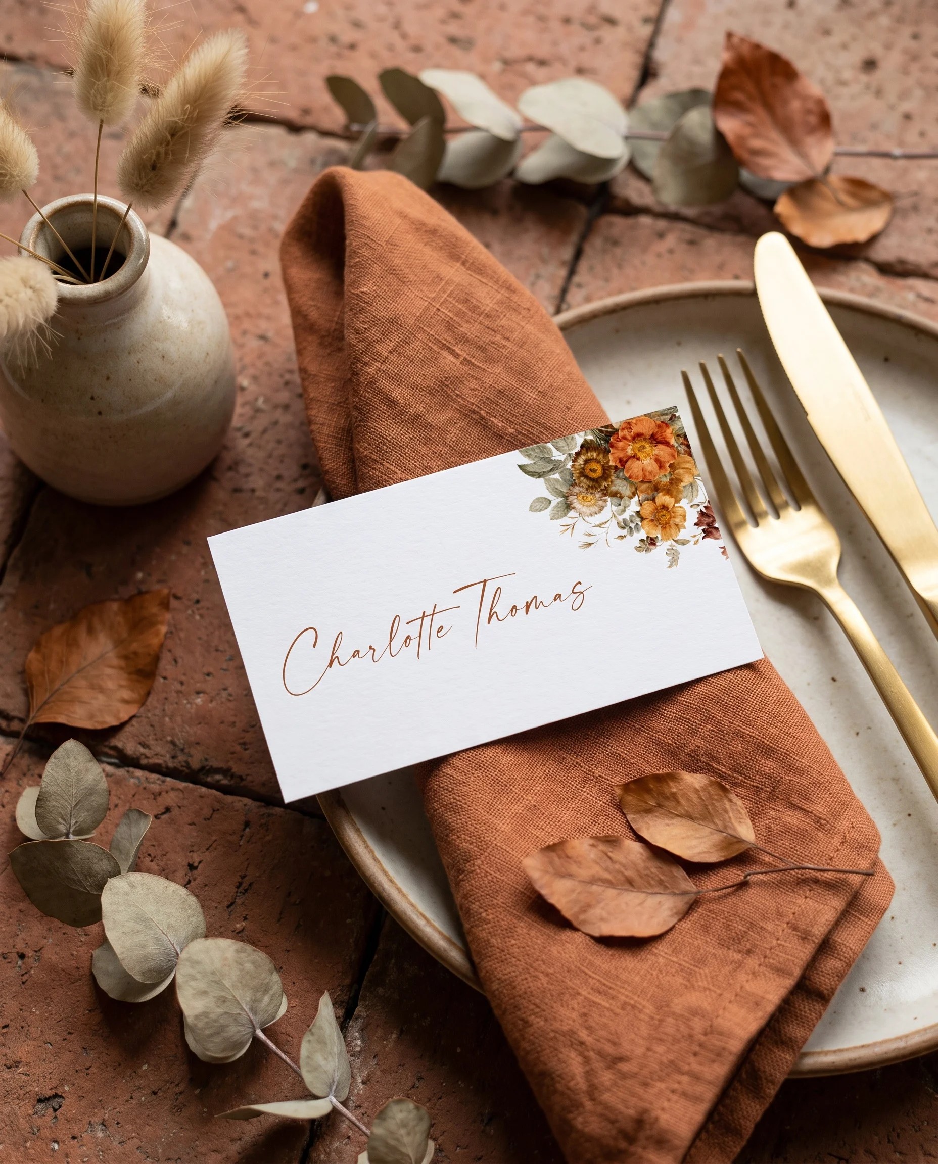 Terracotta Crown wedding place cards — a single card displayed at a set place setting under soft natural light, wedding name cards.