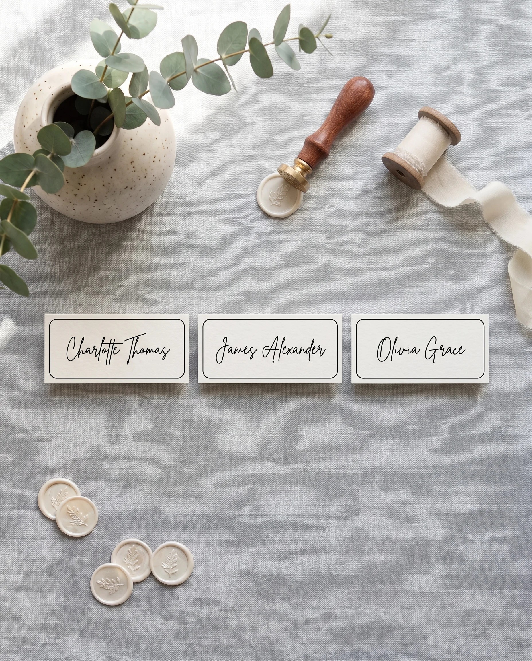 Contour wedding place cards — several cards shown flat lay under soft natural light at a slight overhead angle, wedding place cards.