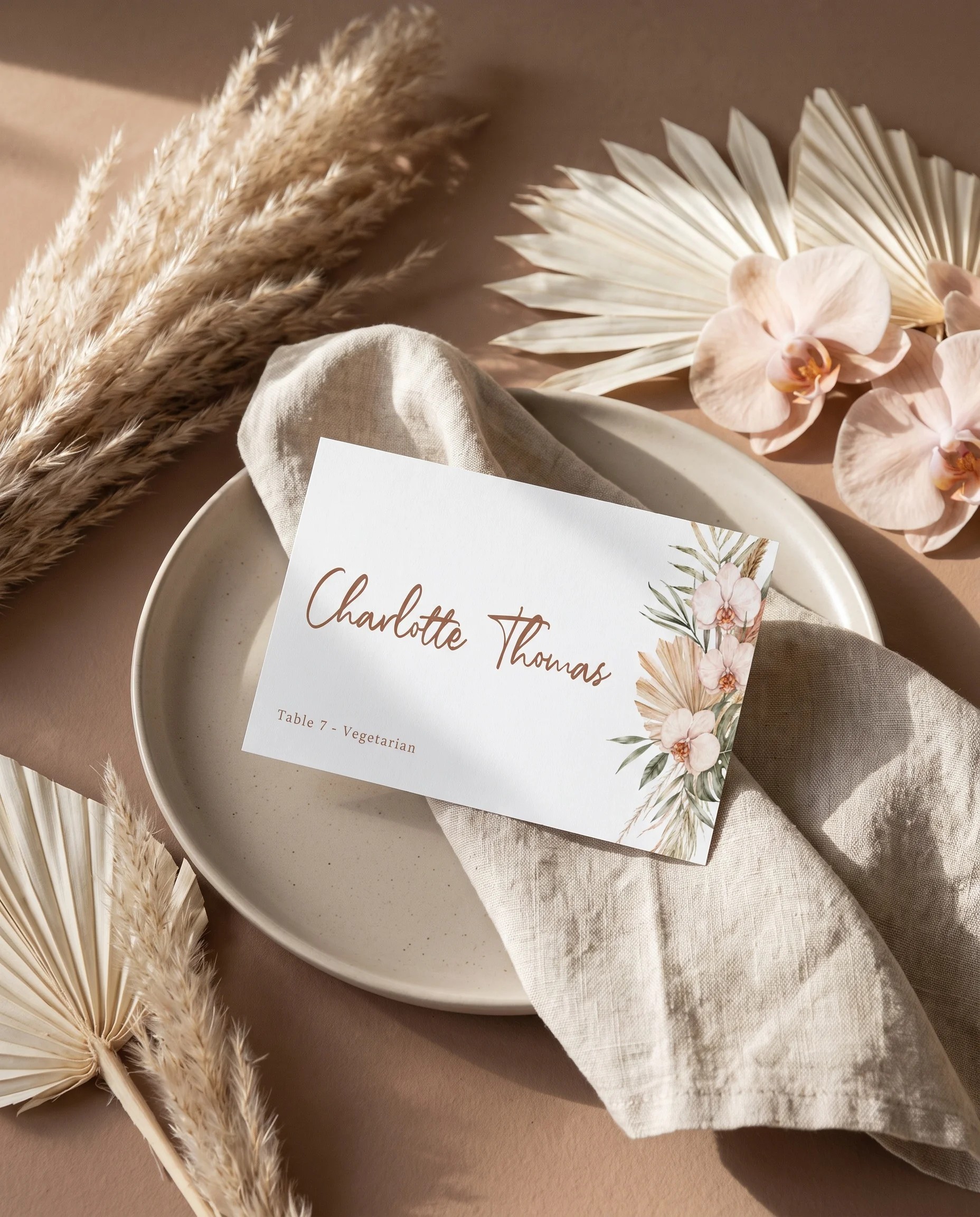 Palm Orchid wedding place cards — a single place card at a set place setting under soft overhead natural light, wedding name cards.