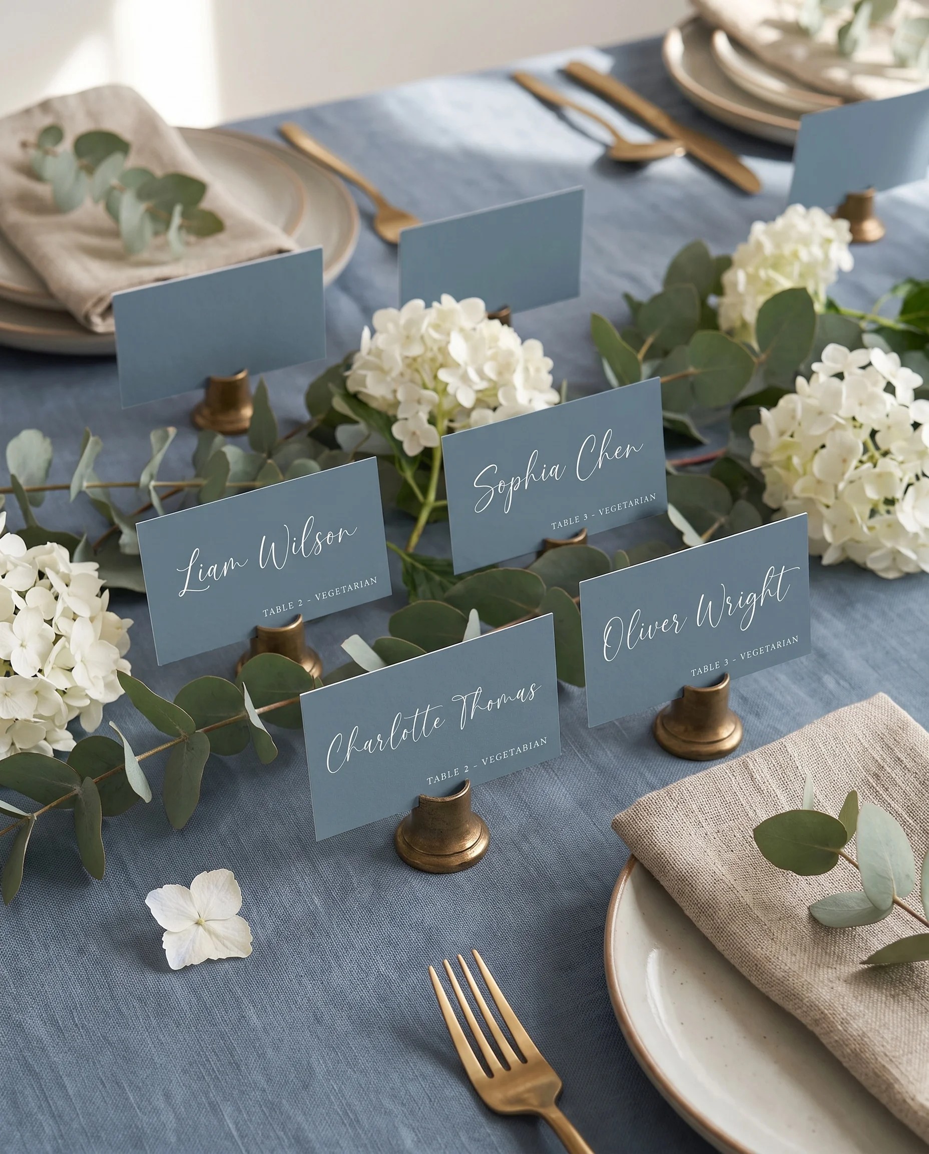 Arrow Crest wedding place cards — arranged on a dressed reception table under soft natural overhead light, place card template.