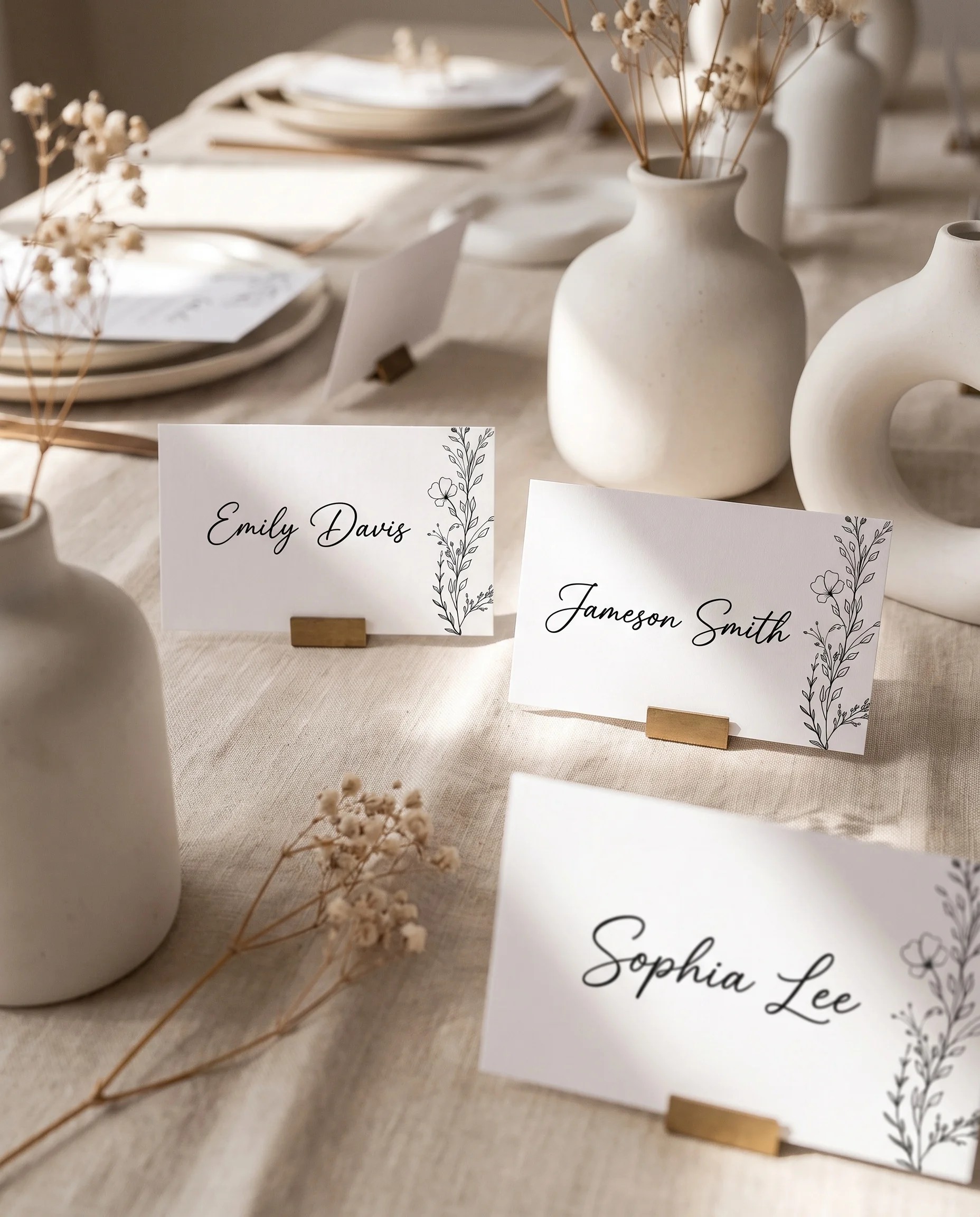 Meadow Sprig wedding place cards — several cards arranged on a dressed reception table under soft natural light, place card template.
