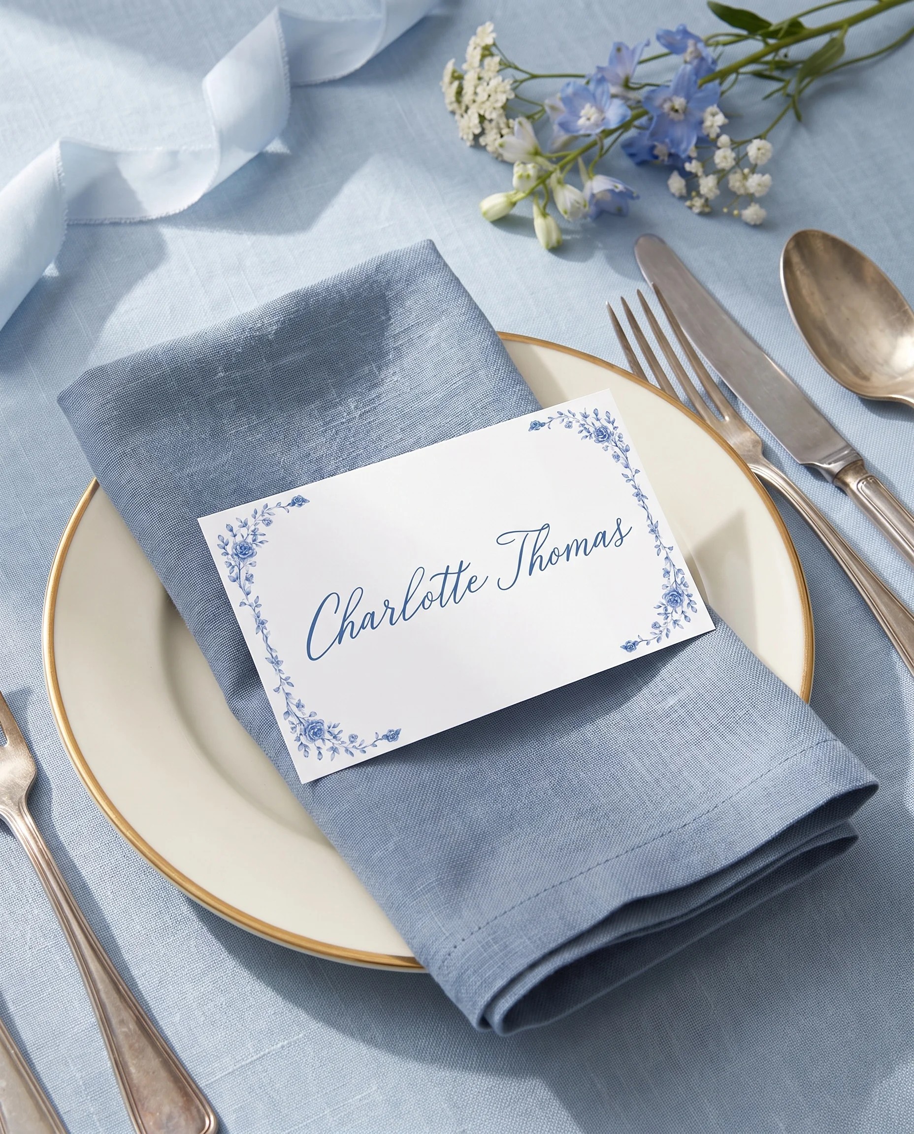 Blue Heron wedding place cards — single card displayed at a set place setting under soft natural light, wedding name cards