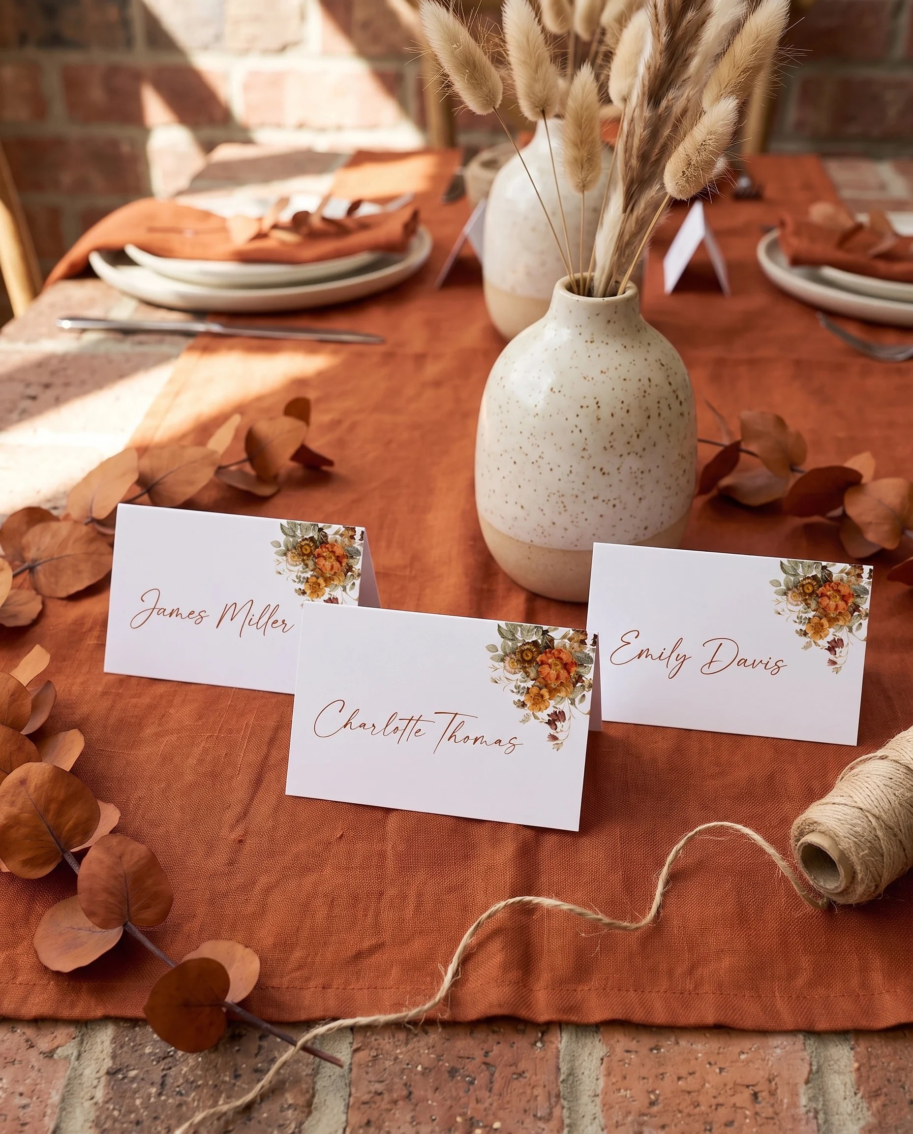 Terracotta Crown wedding place cards — displayed on a dressed reception table under soft natural light, place card template.