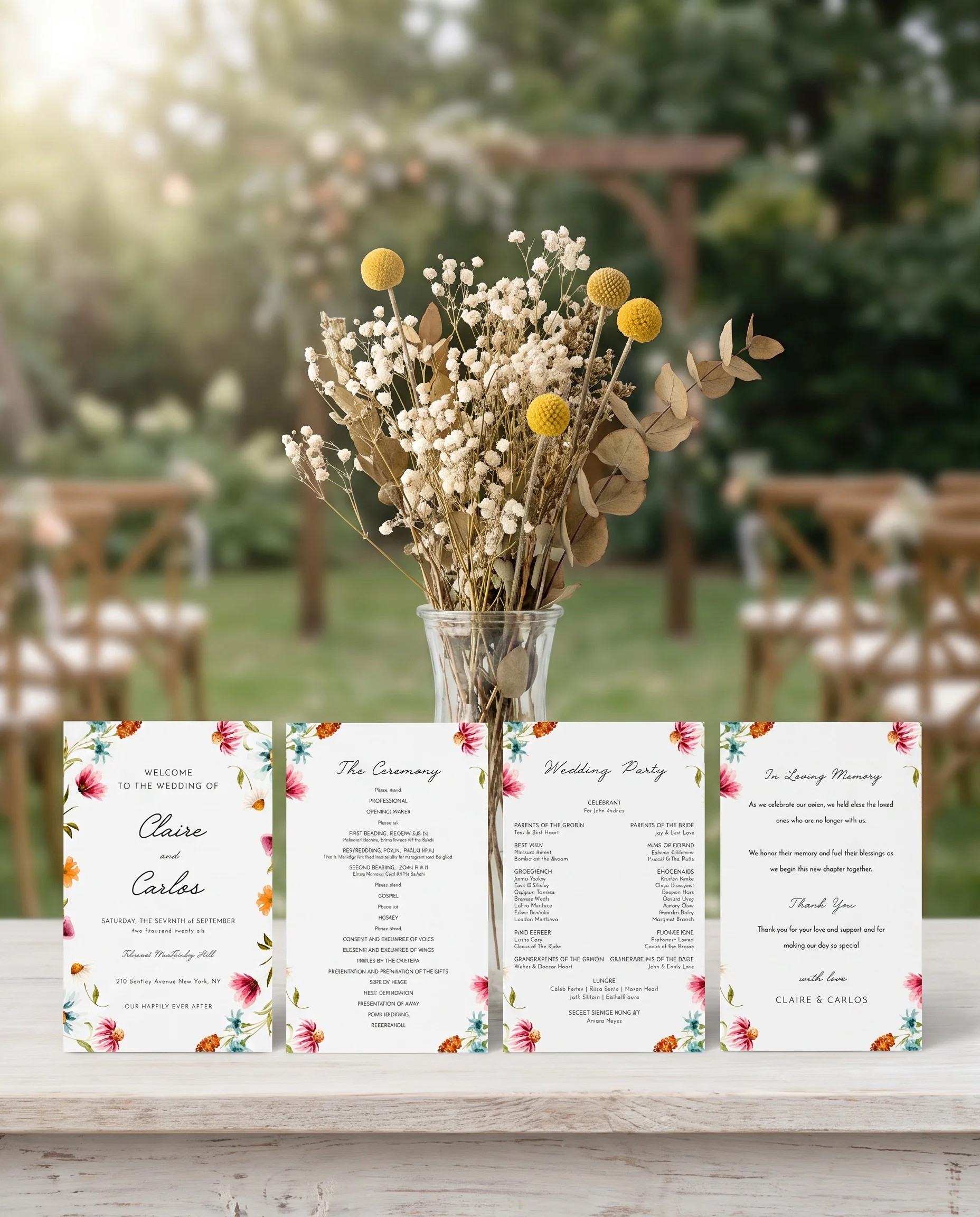 Meadow wedding program — four flat program cards standing upright at a ceremony under soft natural light, wedding program template.