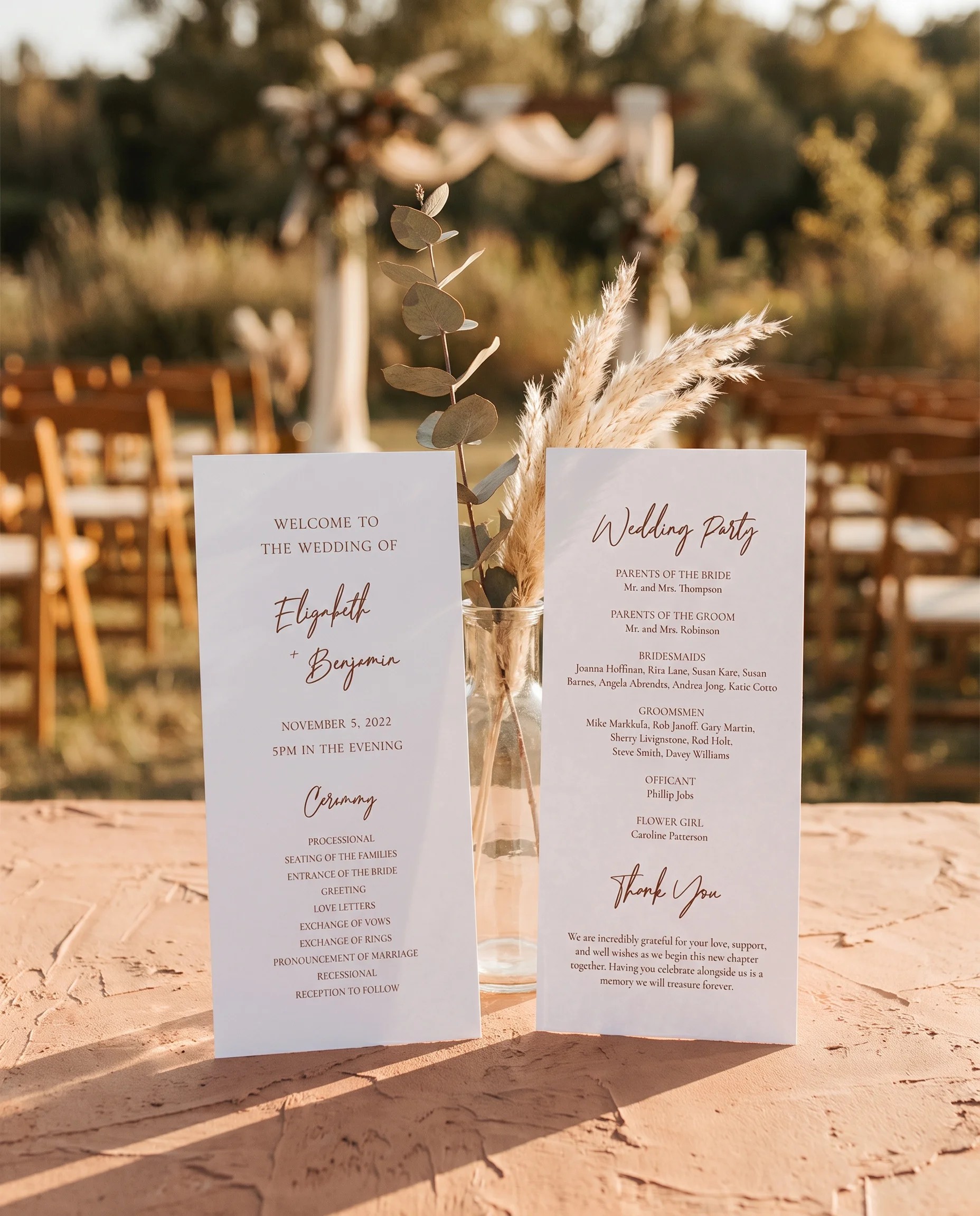 Briar Script wedding program — two flat program cards standing upright at a ceremony under soft natural light, wedding program template.