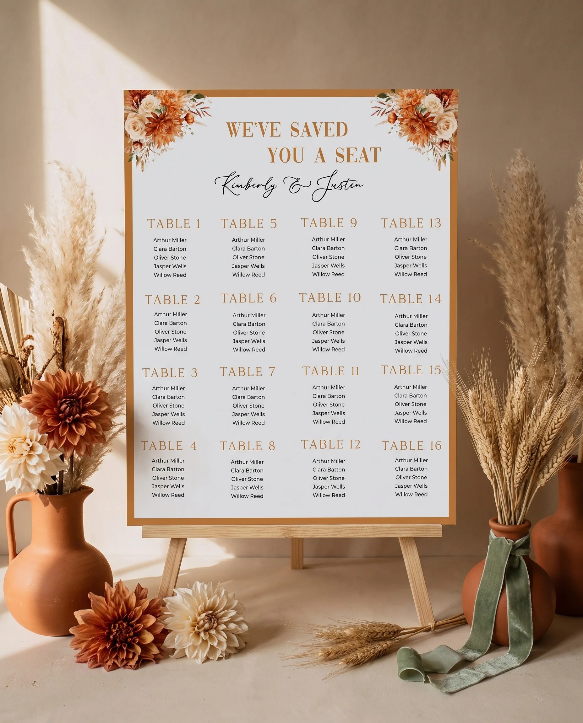 Marigold wedding seating chart — displayed on an easel under soft natural light at a slight overhead angle, wedding seating chart.