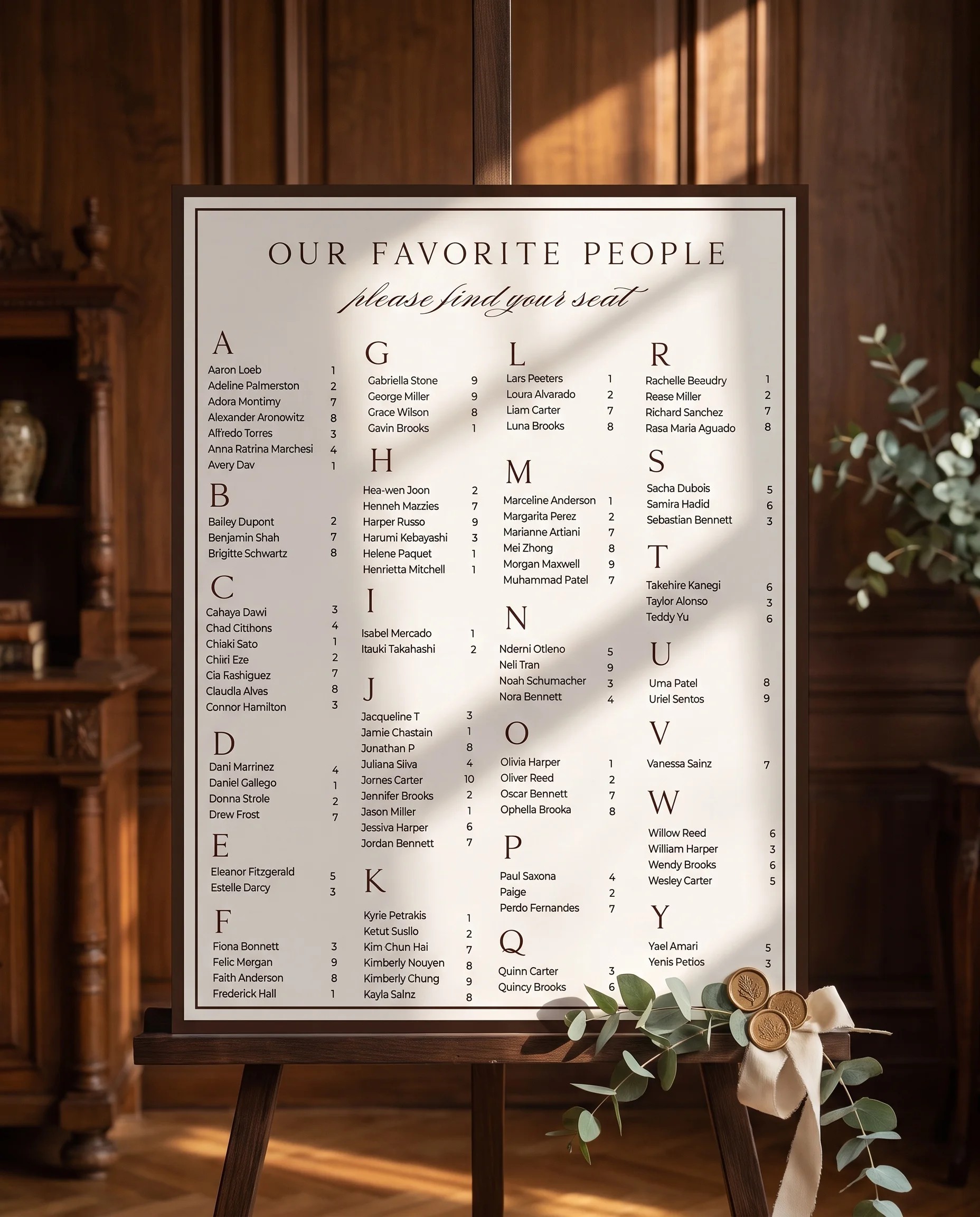 Velour wedding seating chart — displayed on an easel under soft natural light at a slight overhead angle, wedding seating chart