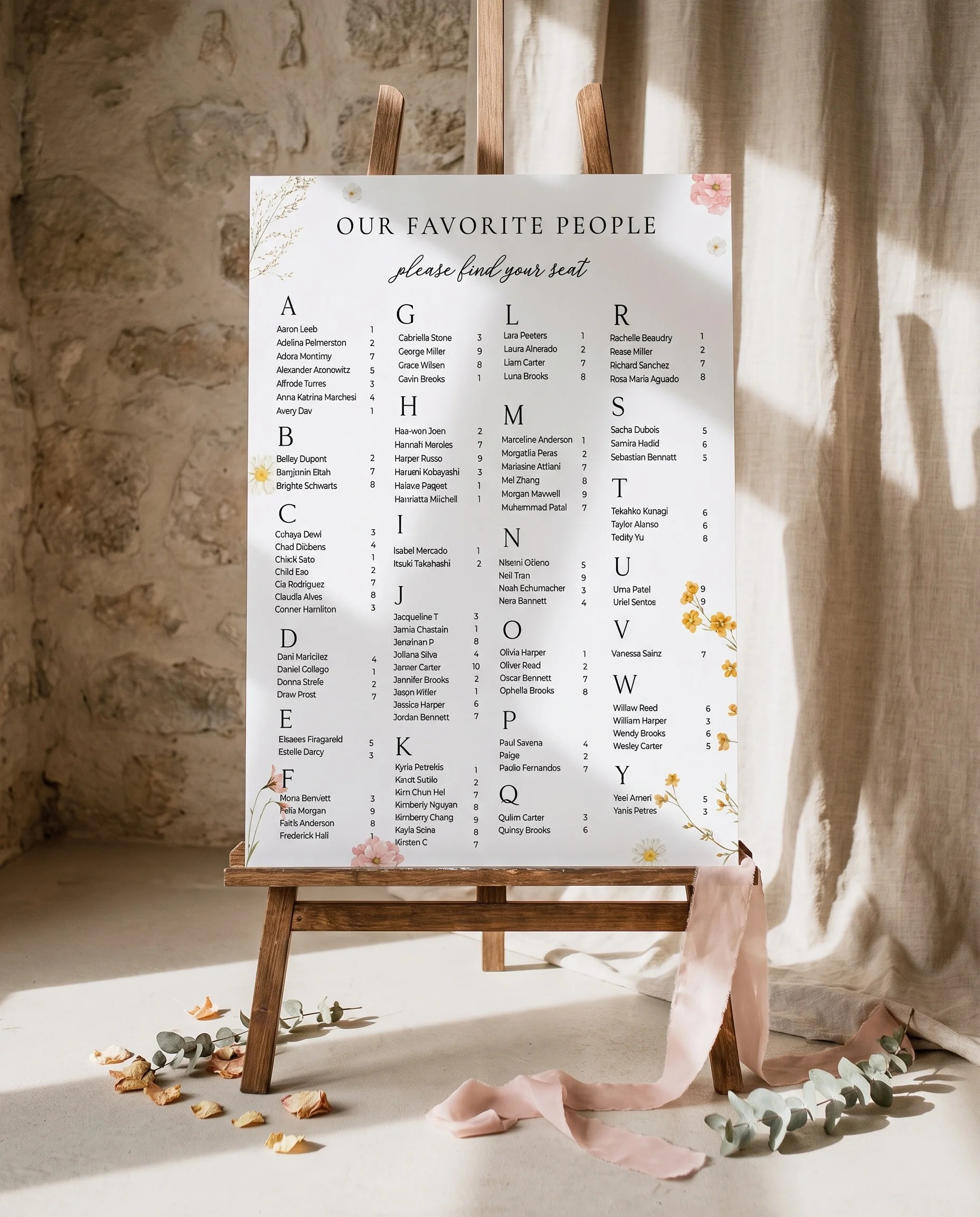 Marigold Petal wedding seating chart — single page displayed on an easel under soft natural light, wedding seating chart.