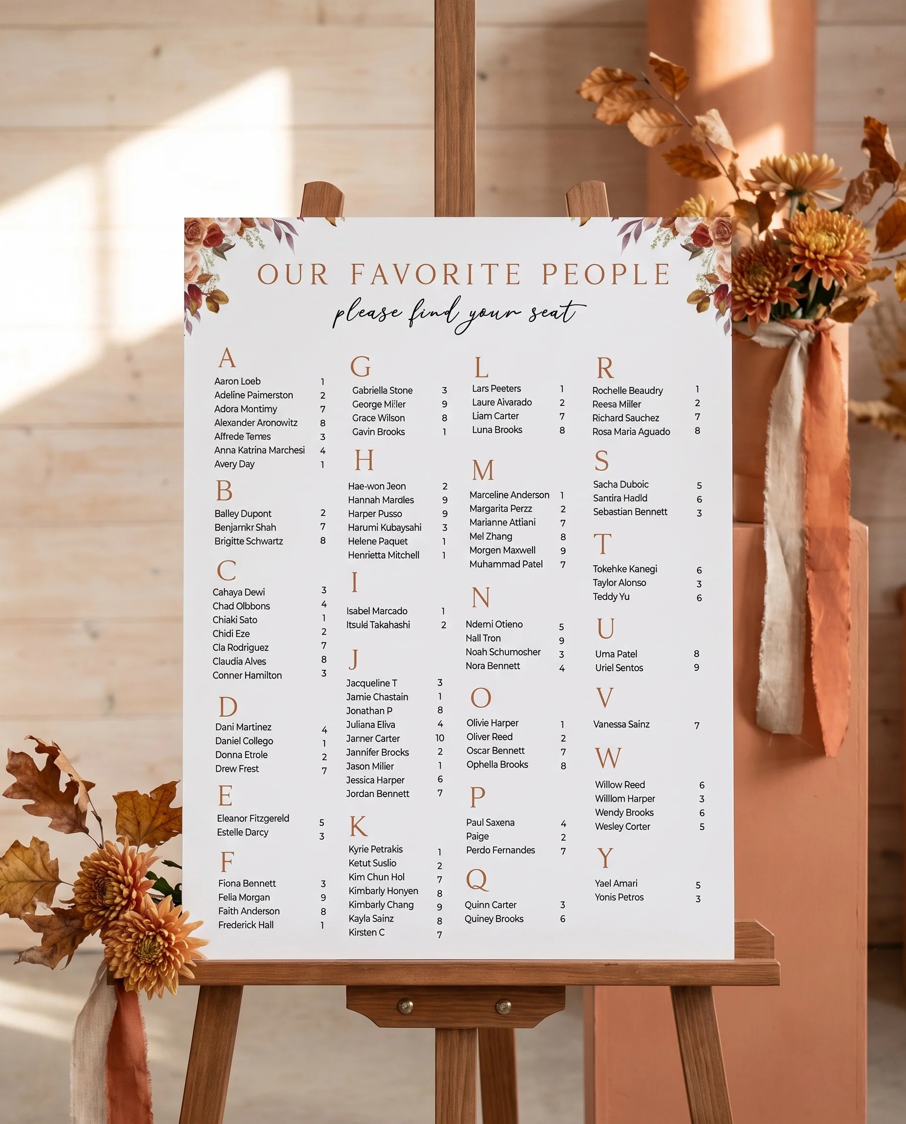 Autumn Bloom wedding seating chart — single page displayed on an easel under soft natural light, wedding seating chart