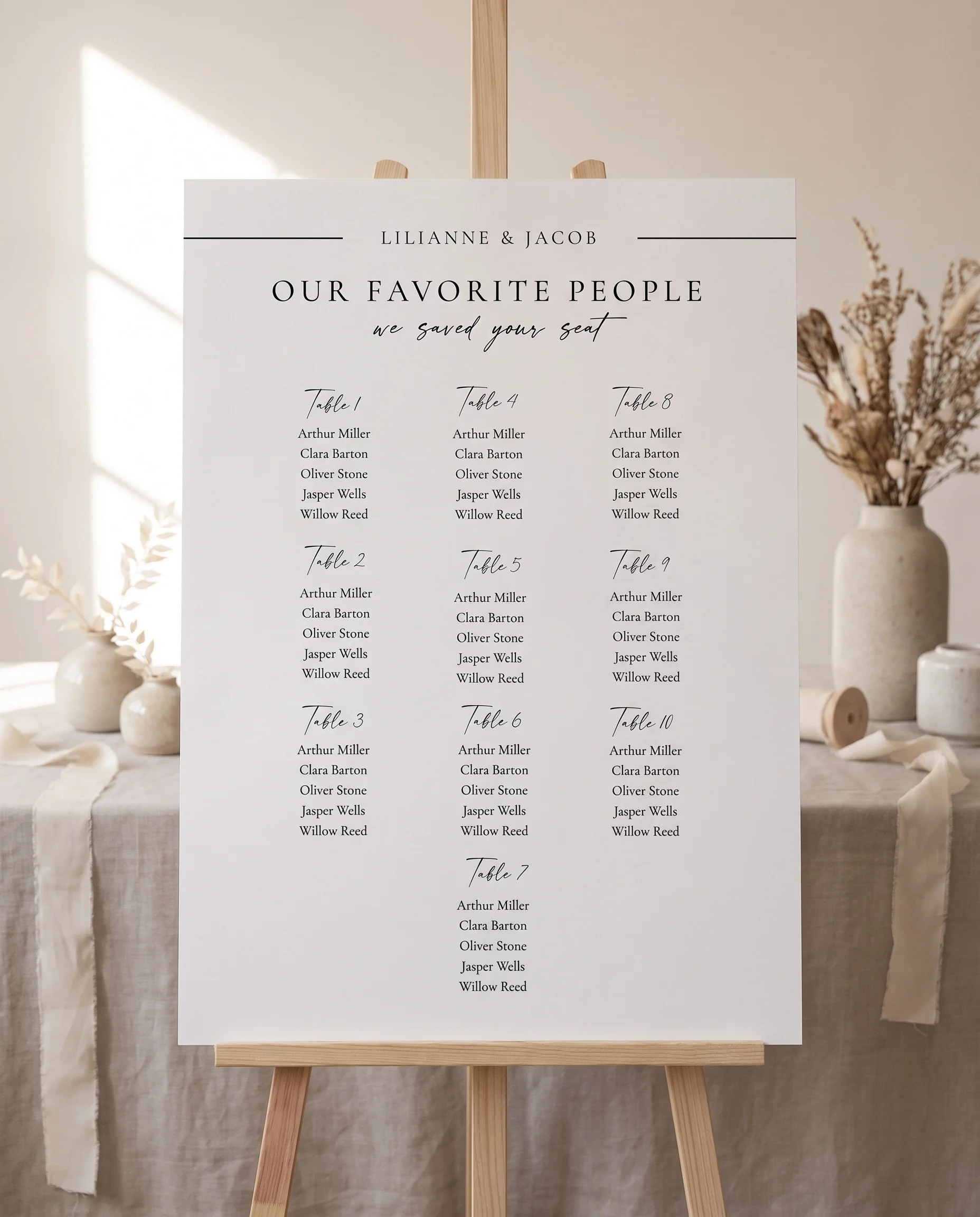 Tonal Reply wedding seating chart — single page displayed on an easel under soft natural light, wedding seating chart