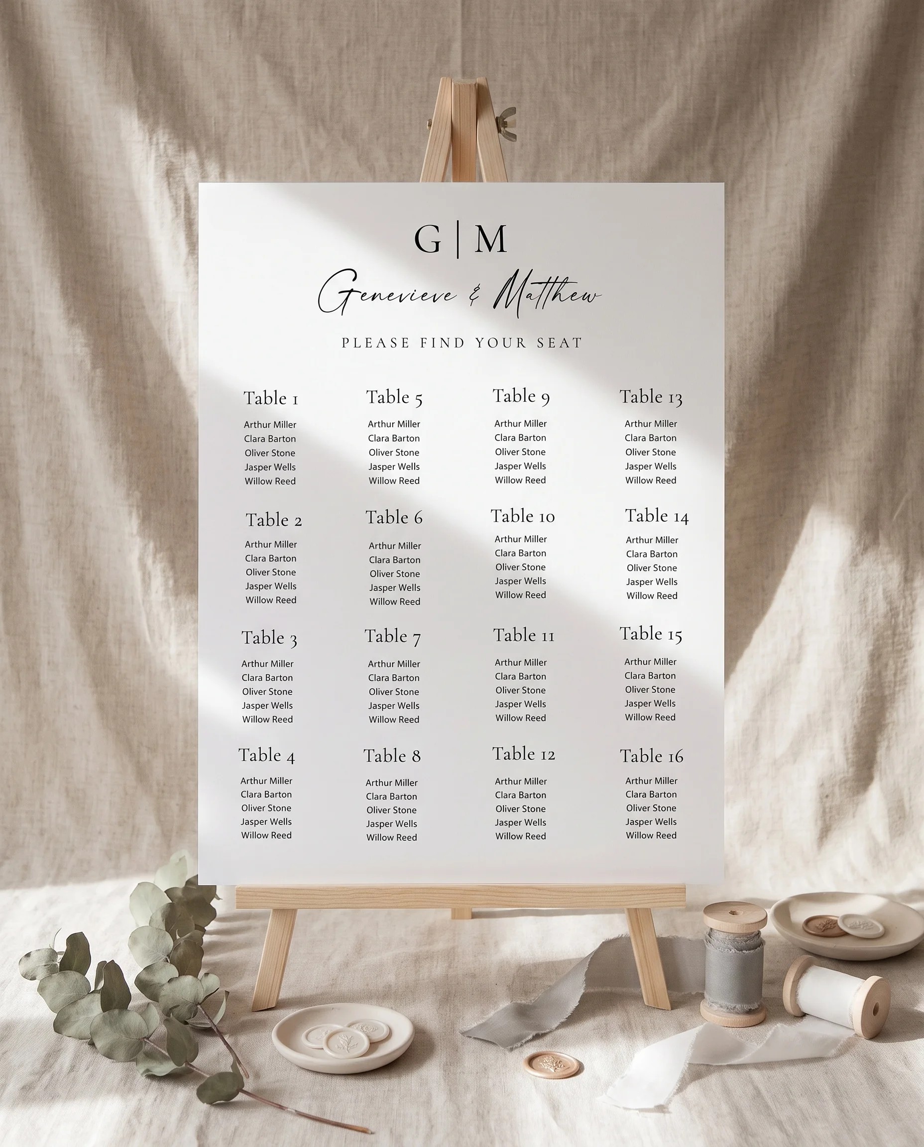 Arcadia wedding seating chart — displayed on an easel under soft natural light with a slight overhead angle, wedding seating chart