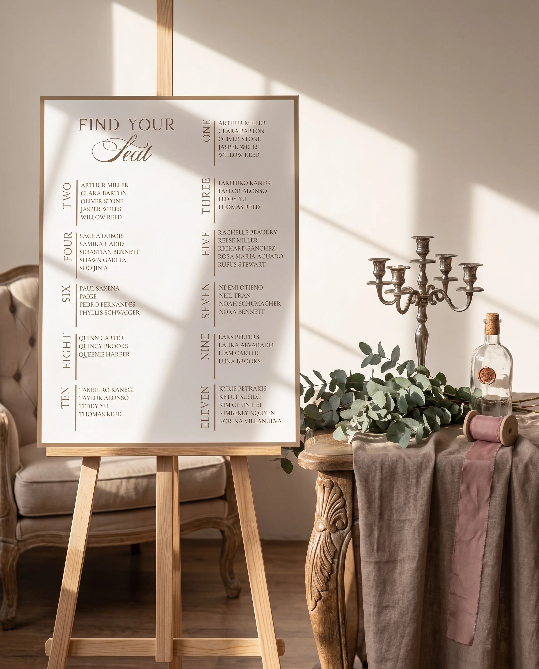 Hinge Script wedding seating chart — single page shown beside furniture for scale under soft natural light, wedding seating chart template