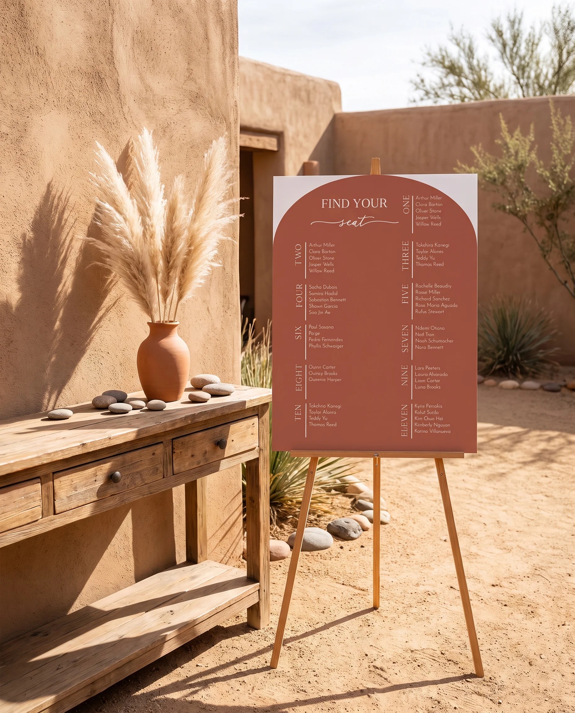 Desert Bloom wedding seating chart — single page shown beside furniture for scale under soft natural light, wedding seating chart template
