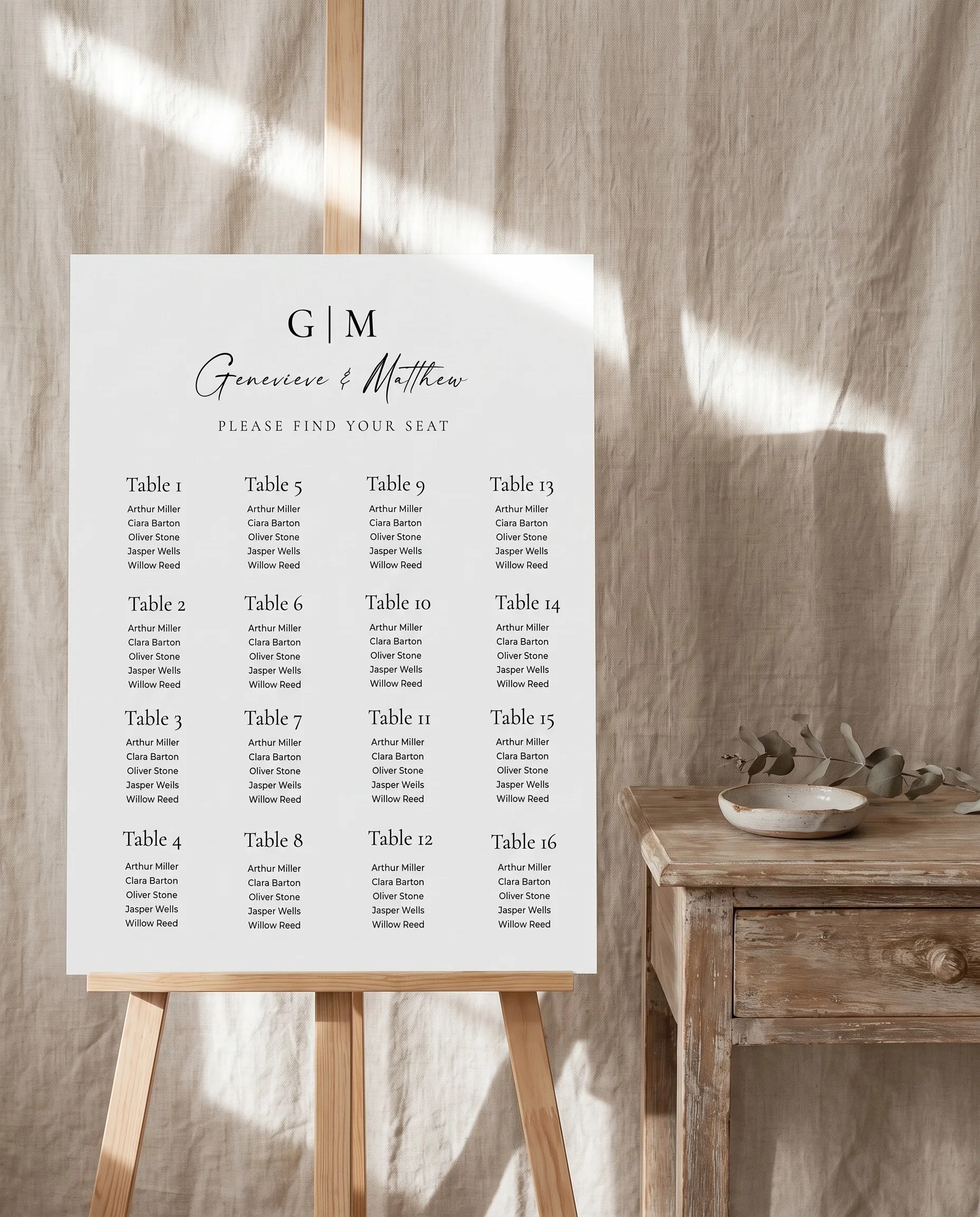 Arcadia wedding seating chart — displayed beside furniture for scale under soft natural light, premium editorial paper, wedding seating chart template