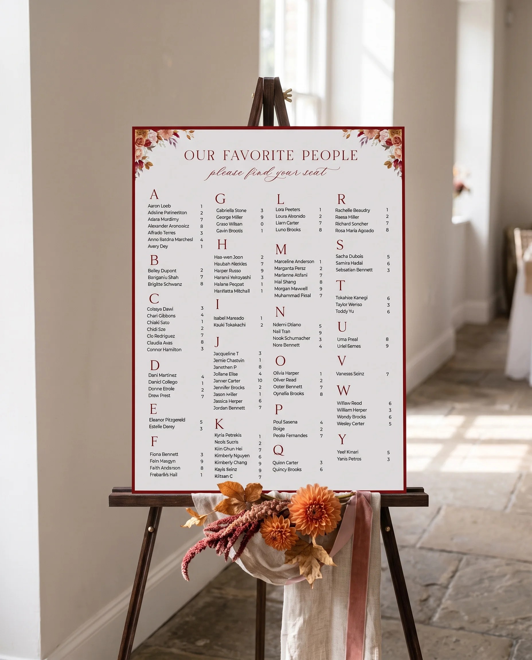 Autumn Blush wedding seating chart — displayed on an easel under soft natural light with a slight overhead angle, wedding seating chart