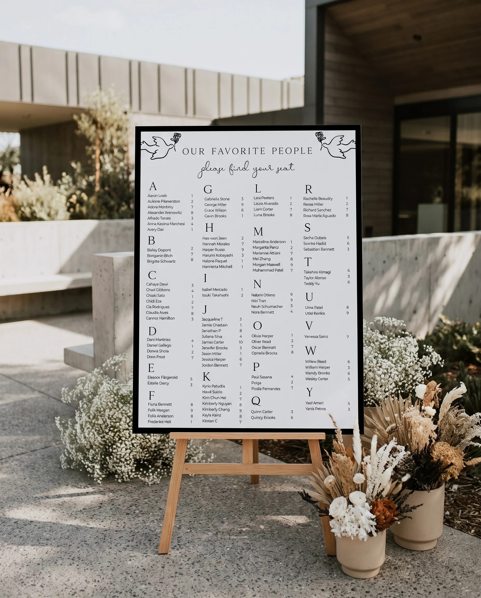 Sketchbook Bow wedding seating chart — displayed near a reception entrance under soft natural light, seating chart template.