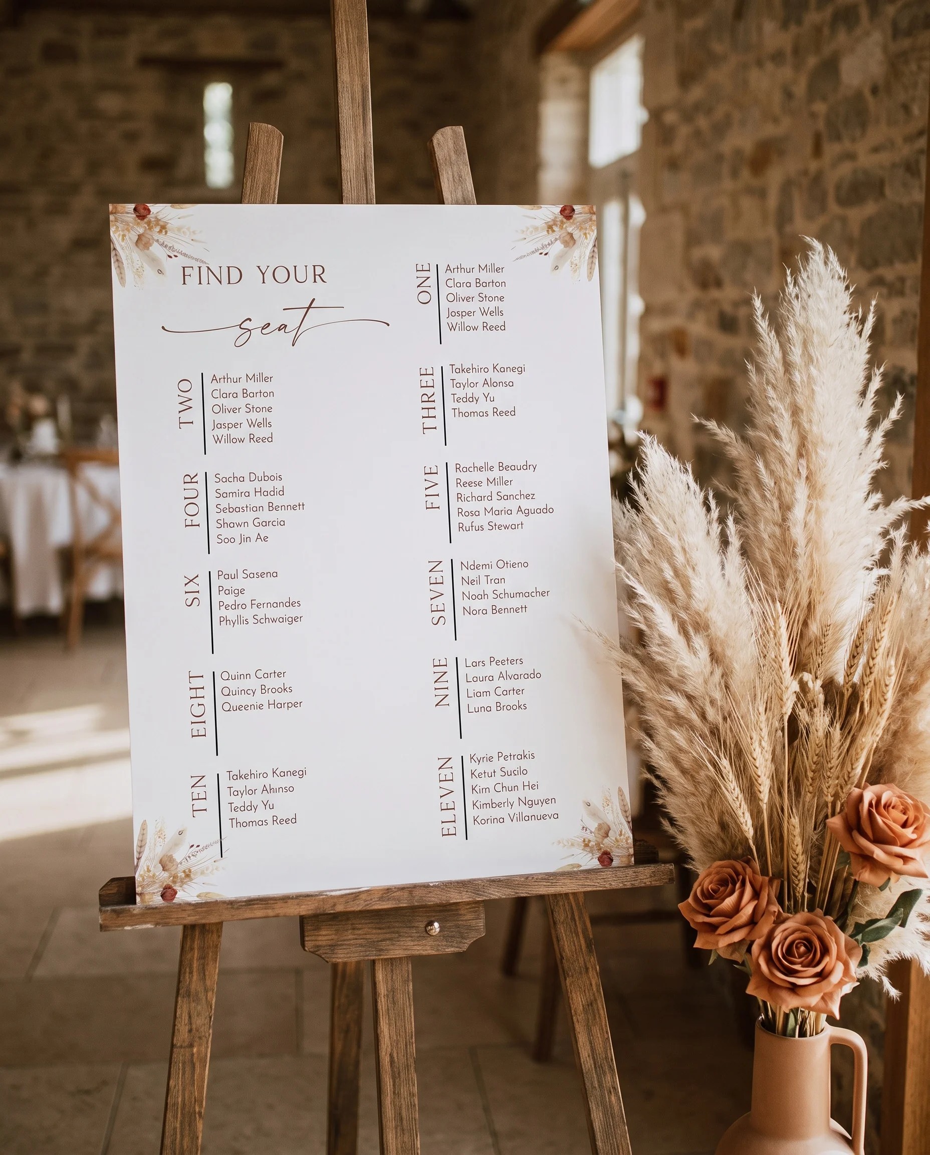Harvest Script wedding seating chart — displayed at a reception entrance under soft natural light on premium editorial paper, seating chart template