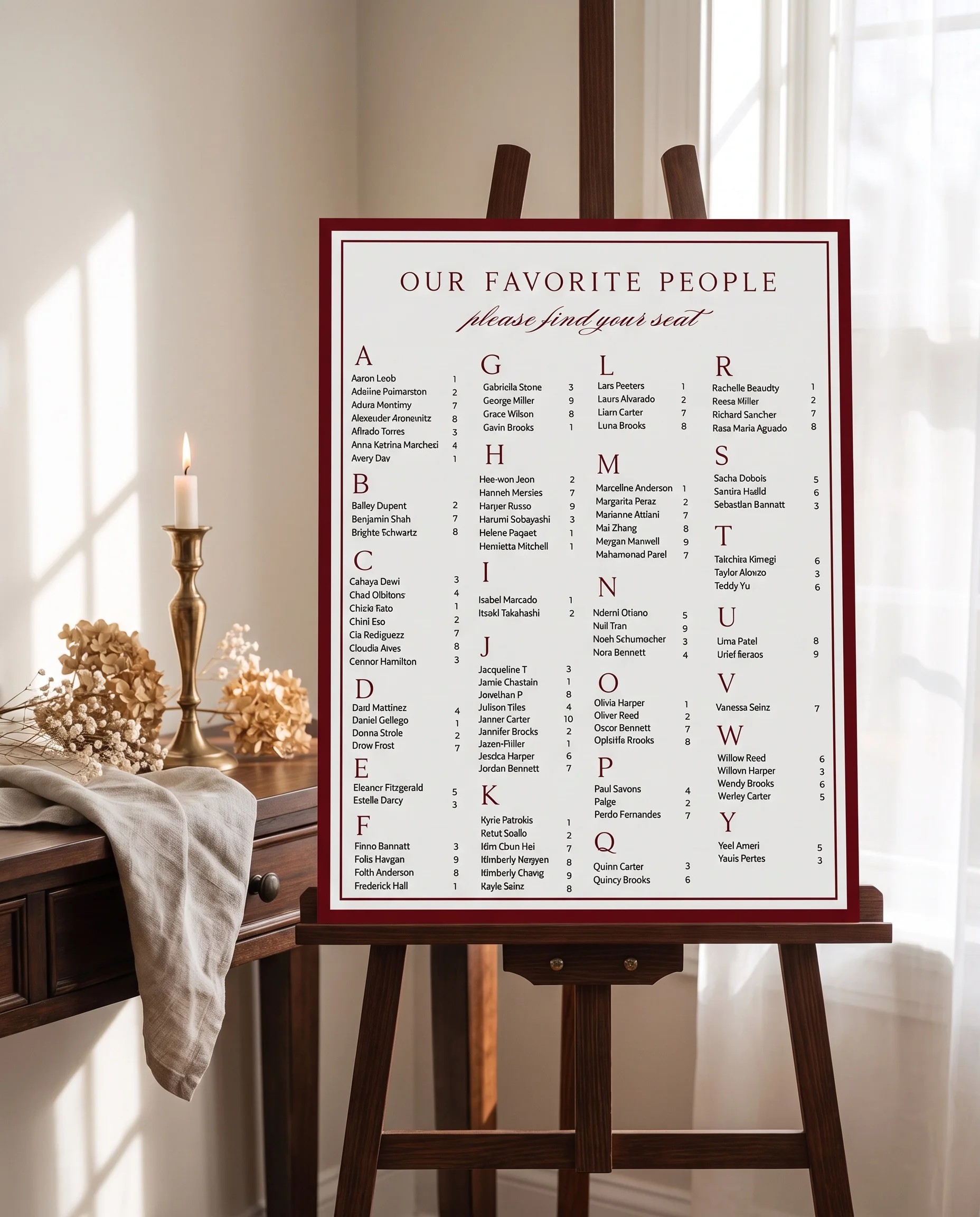 Claret Filigree wedding seating chart — single page shown beside furniture for scale under soft overhead light, wedding seating chart template