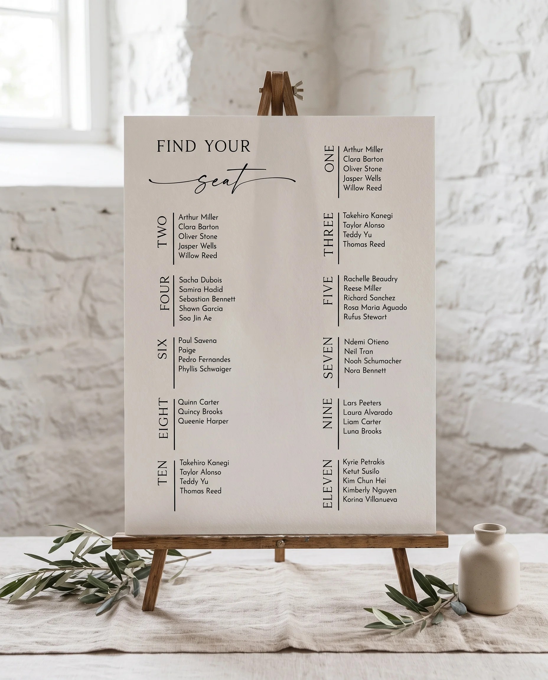 Liminal wedding seating chart — single page displayed on an easel under soft natural light at a slight overhead angle, wedding seating chart.
