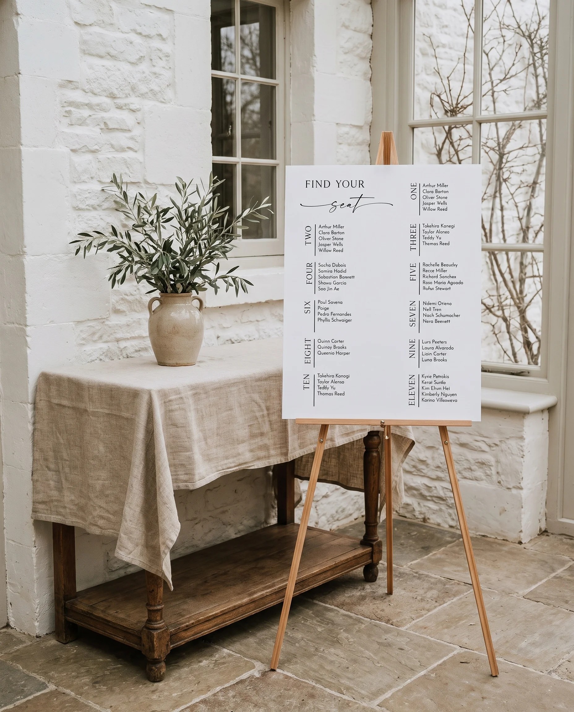 Liminal wedding seating chart — single page shown beside furniture for scale under soft natural light, wedding seating chart template
