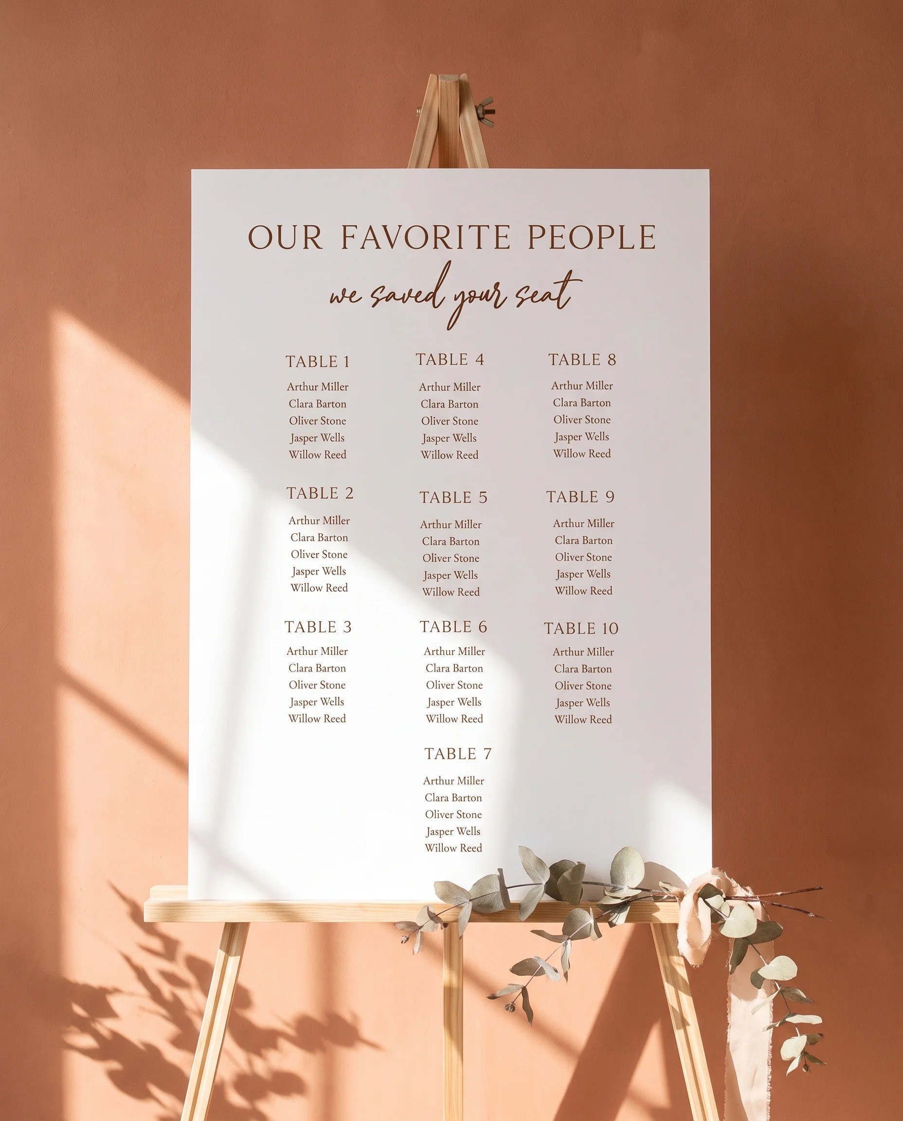 Briar Script wedding seating chart — displayed on an easel under soft natural light with a slight overhead angle, wedding seating chart.