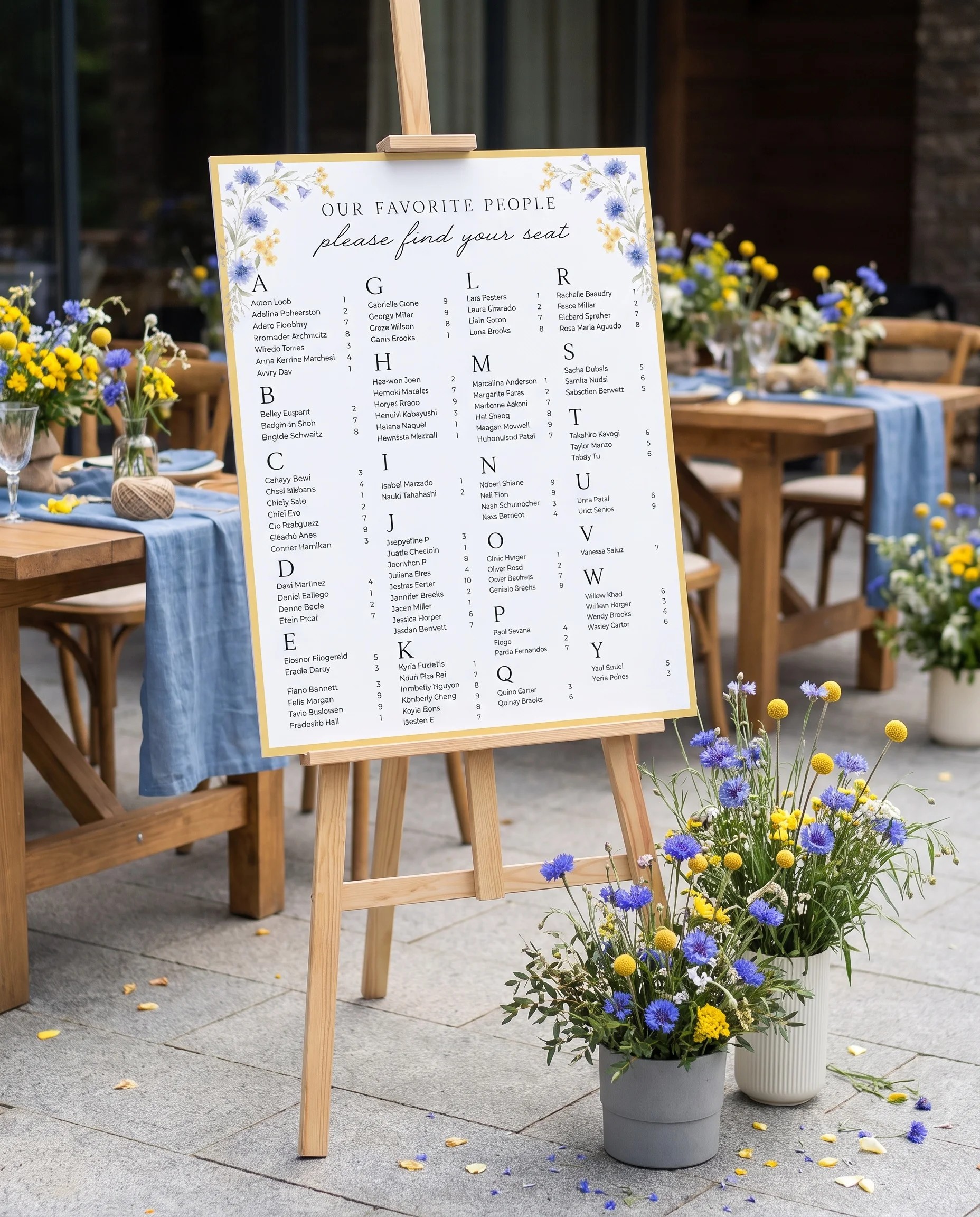 Cornflower wedding seating chart — displayed at a reception entrance under soft natural light with a slight overhead angle, seating chart template