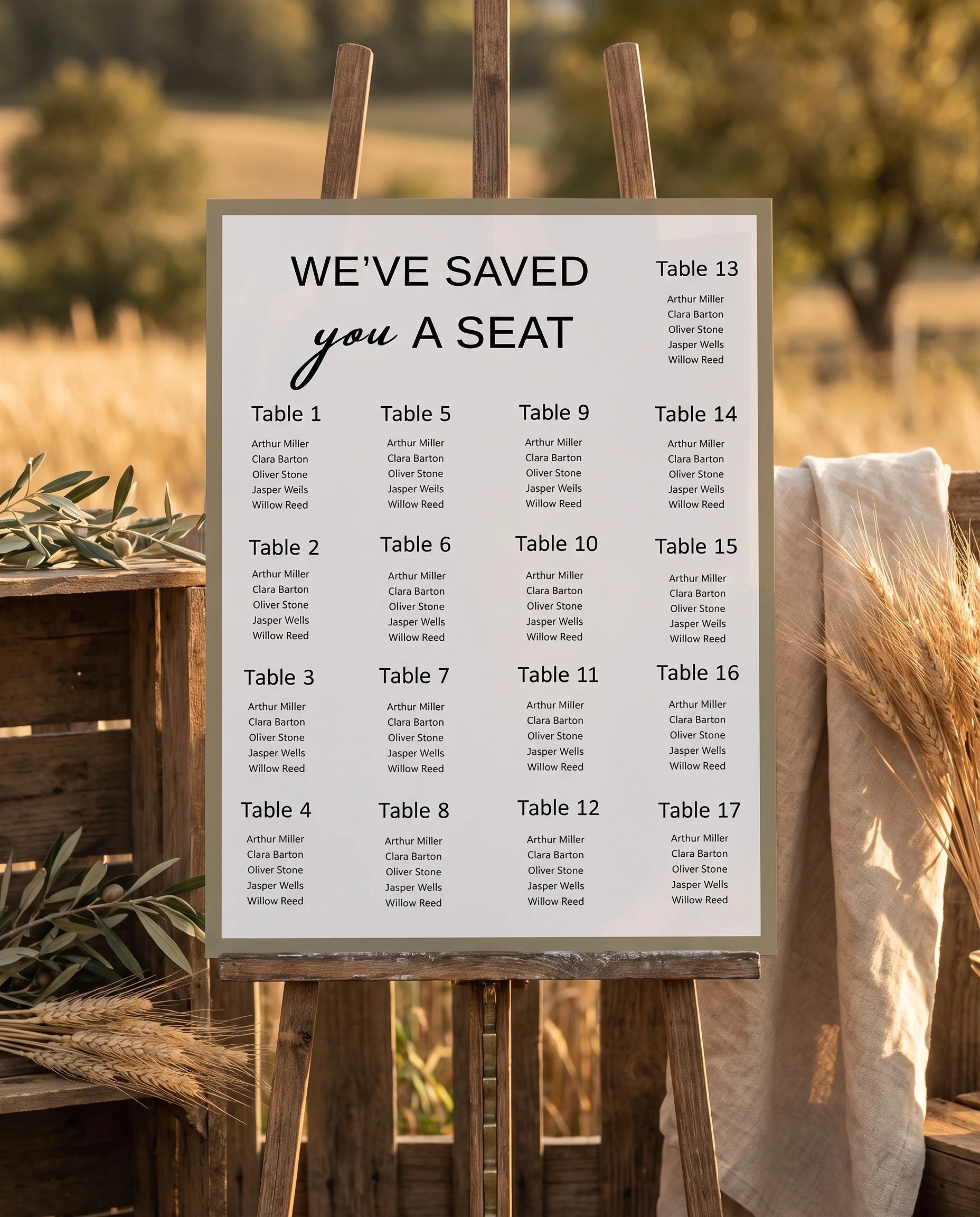 Golden Vale wedding seating chart — displayed on an easel under soft natural light with a slight overhead angle, wedding seating chart