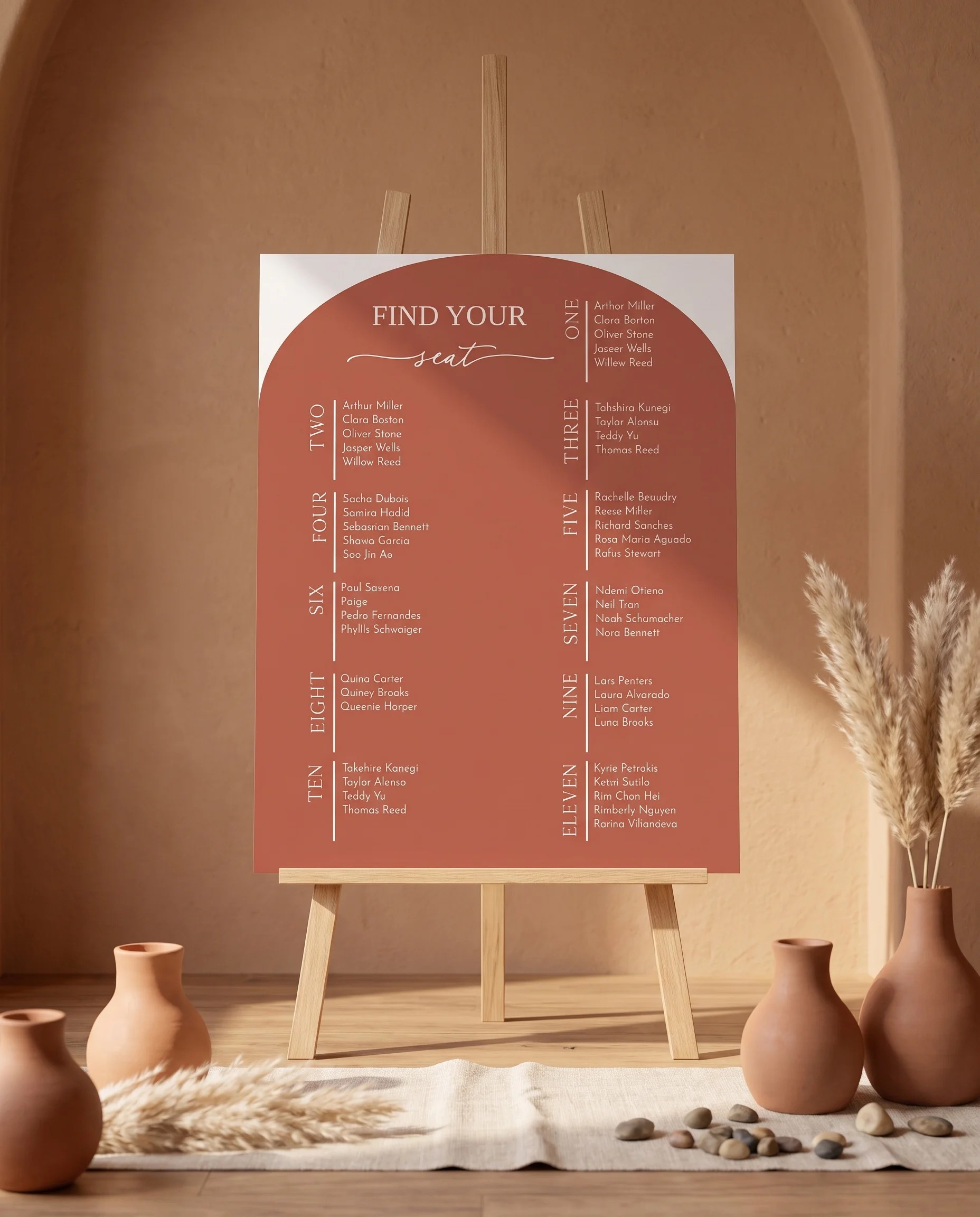 Desert Bloom wedding seating chart — displayed on an easel under soft natural light at a slight overhead angle, wedding seating chart.