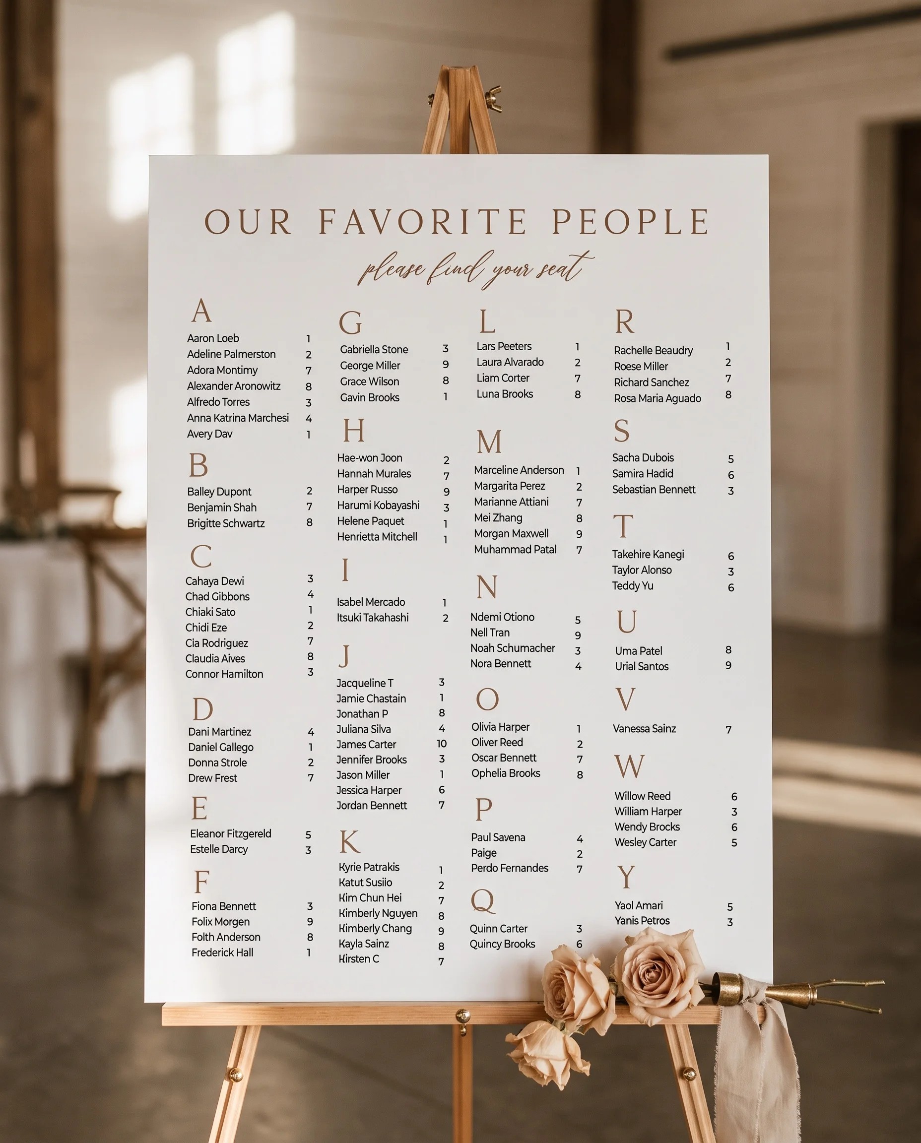Sepia Crest wedding seating chart — single page displayed on an easel under soft natural light, wedding seating chart.