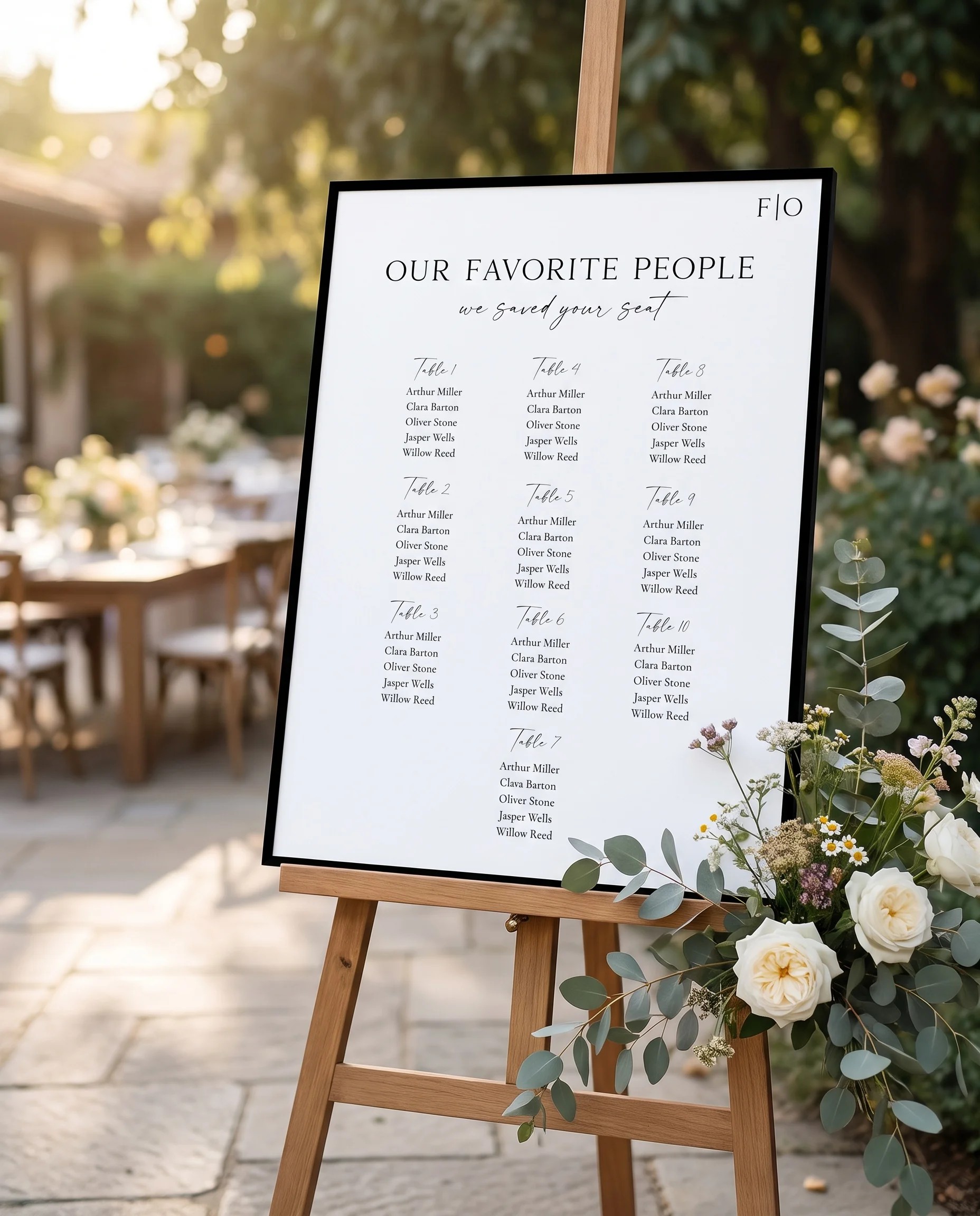 Lumen Frame wedding seating chart — displayed near a reception entrance under soft natural light, seating chart template
