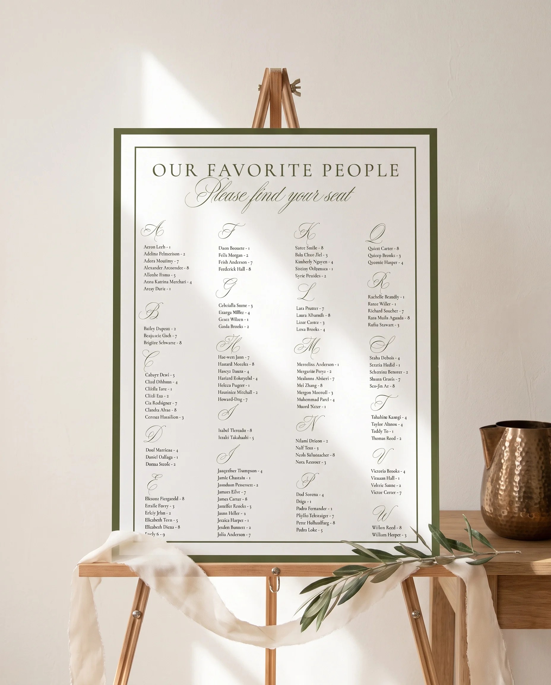 Verdant Filigree wedding seating chart — displayed on an easel under soft natural light with a slight overhead angle, wedding seating chart.
