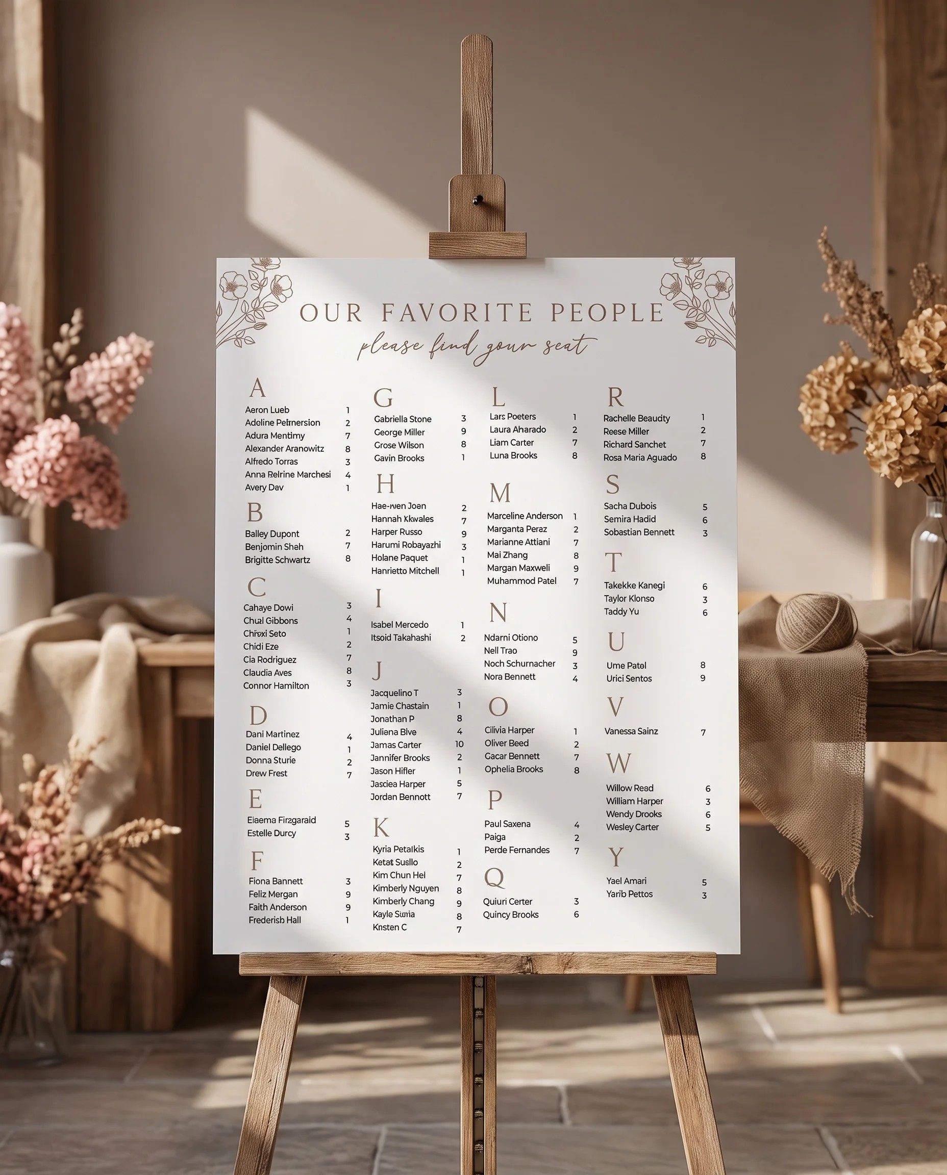 Anemora wedding seating chart — displayed on an easel under soft natural light with a slight overhead angle, wedding seating chart